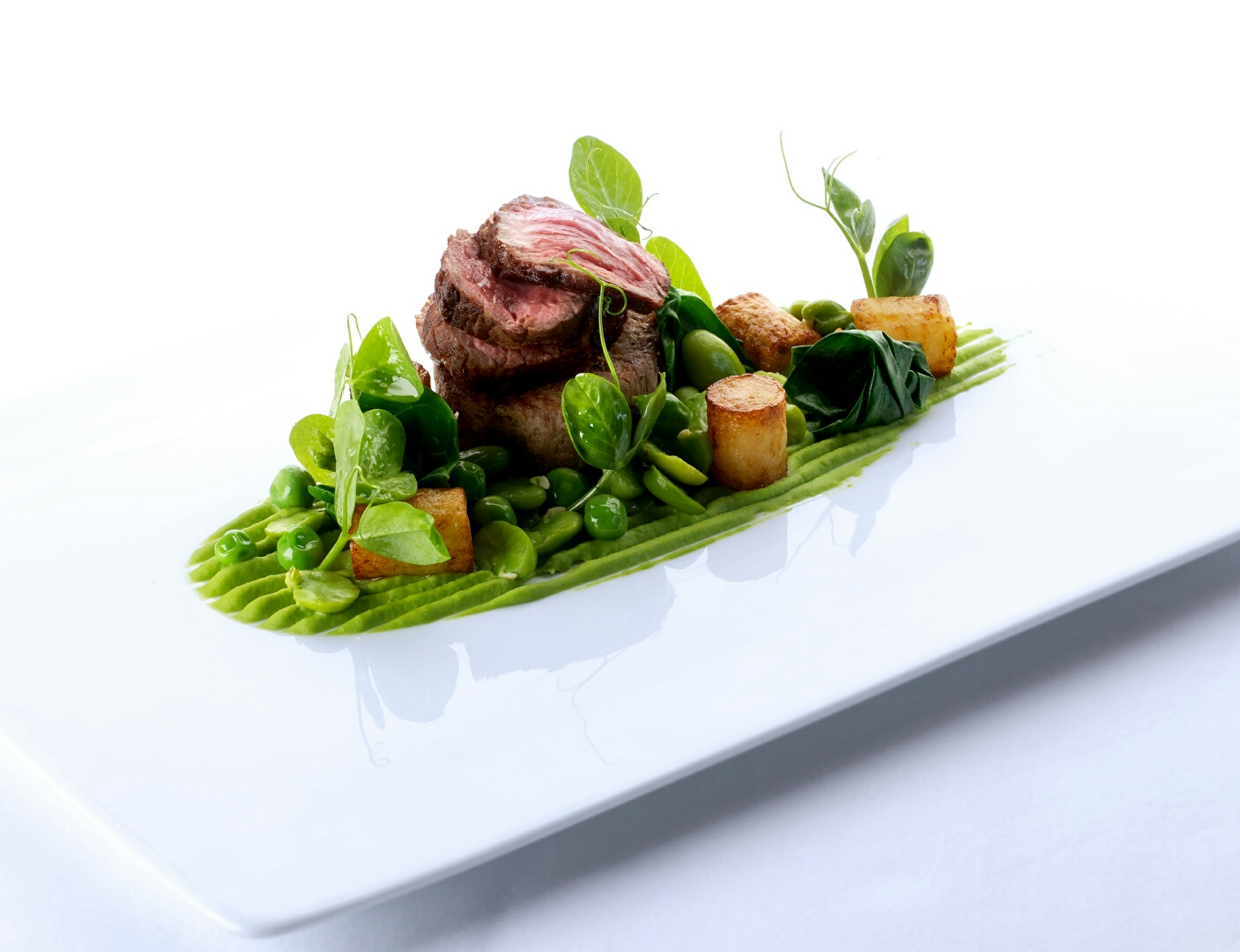 Gourmet dish at Manor House, featuring tender meat and vibrant vegetables for events.
