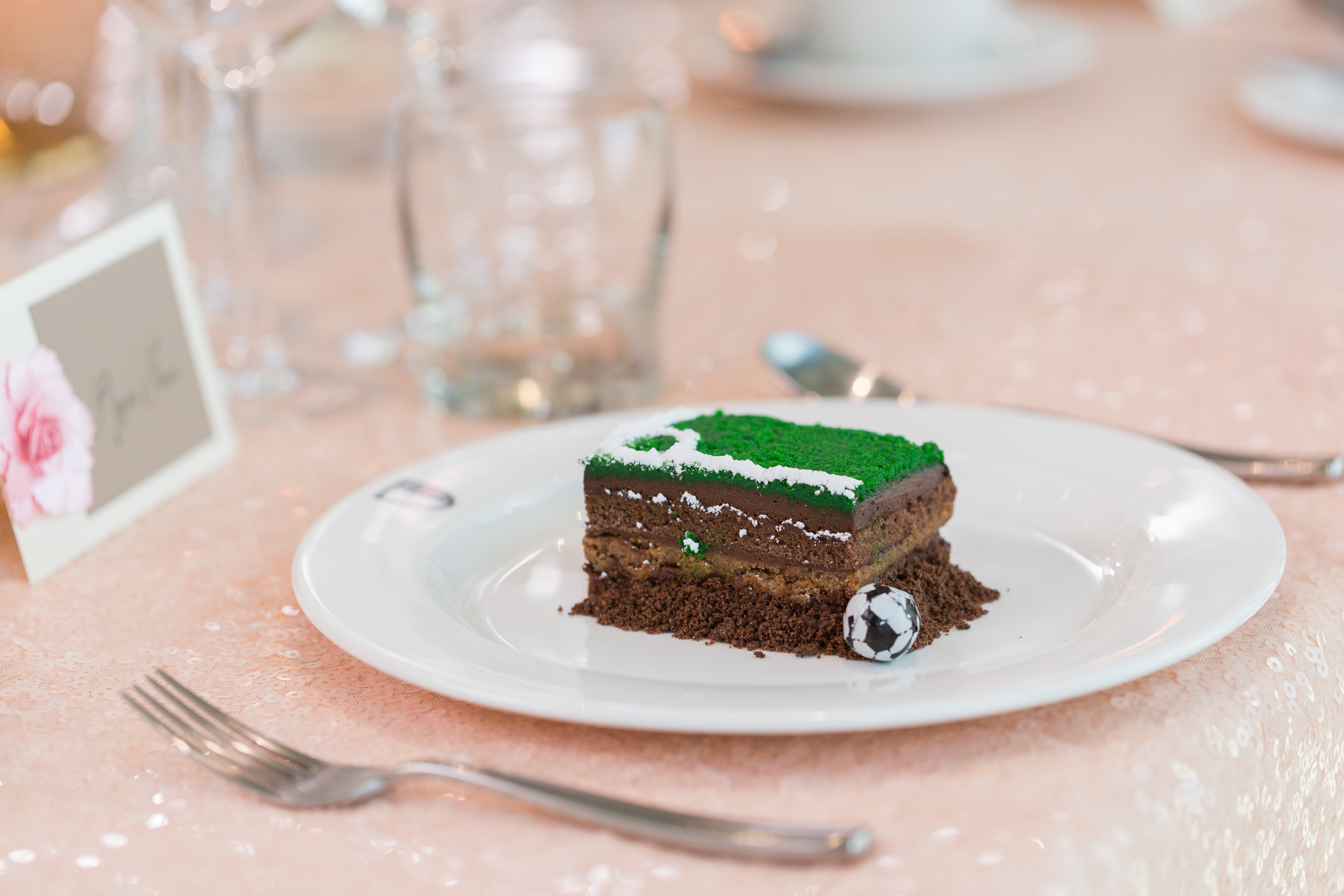 Elegant layered cake with green frosting at Hotel Football's Stadium Suite event.