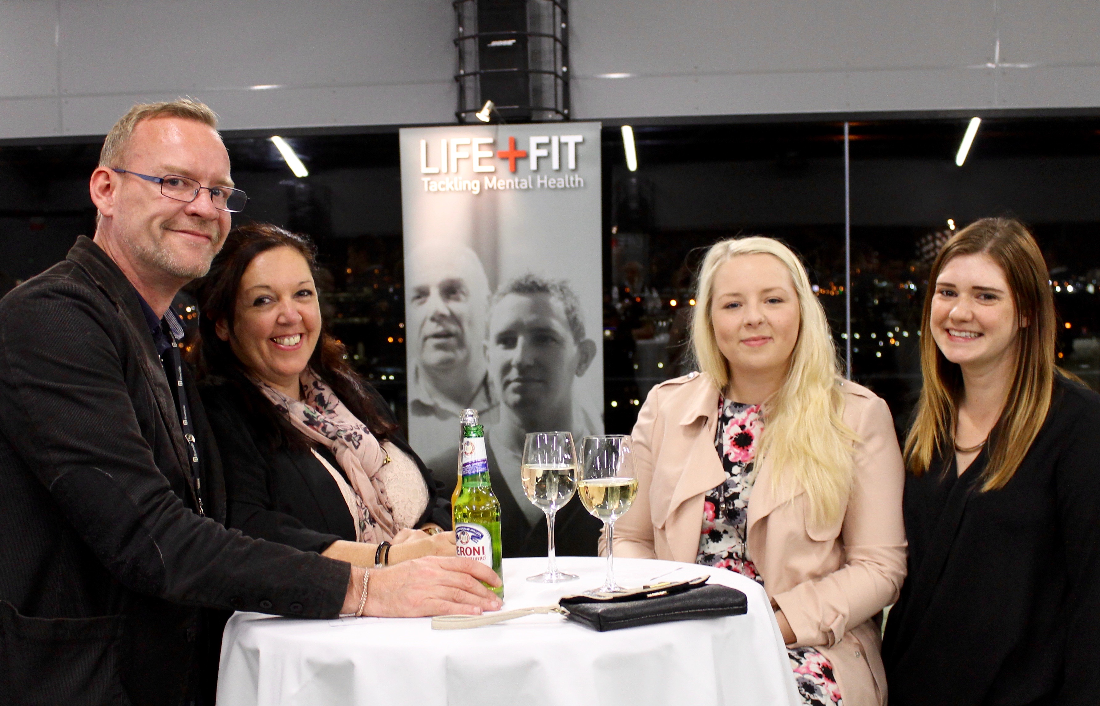 Networking event at Hotel Football with attendees discussing health and wellness.