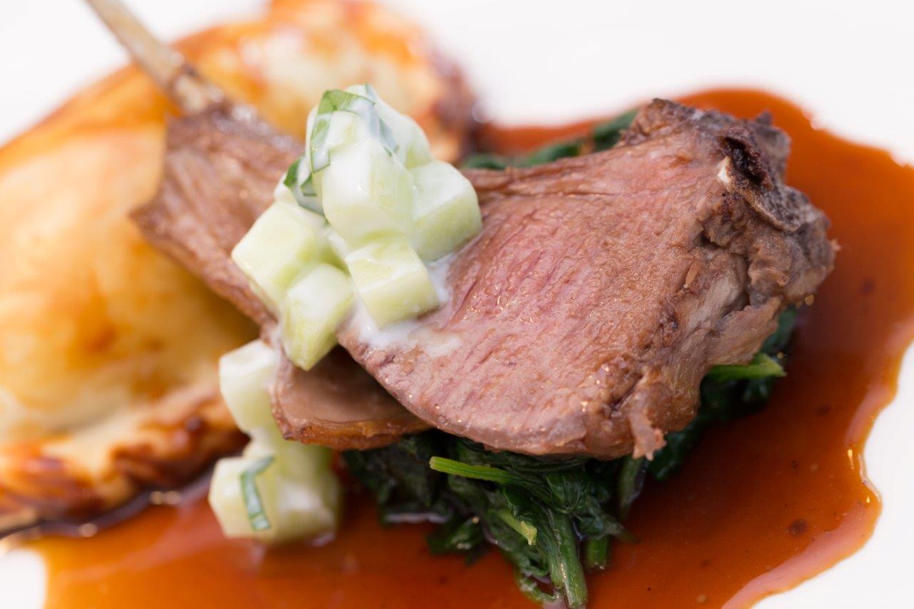 Elegant lamb dish with cucumber, perfect for upscale events at Hotel Football.