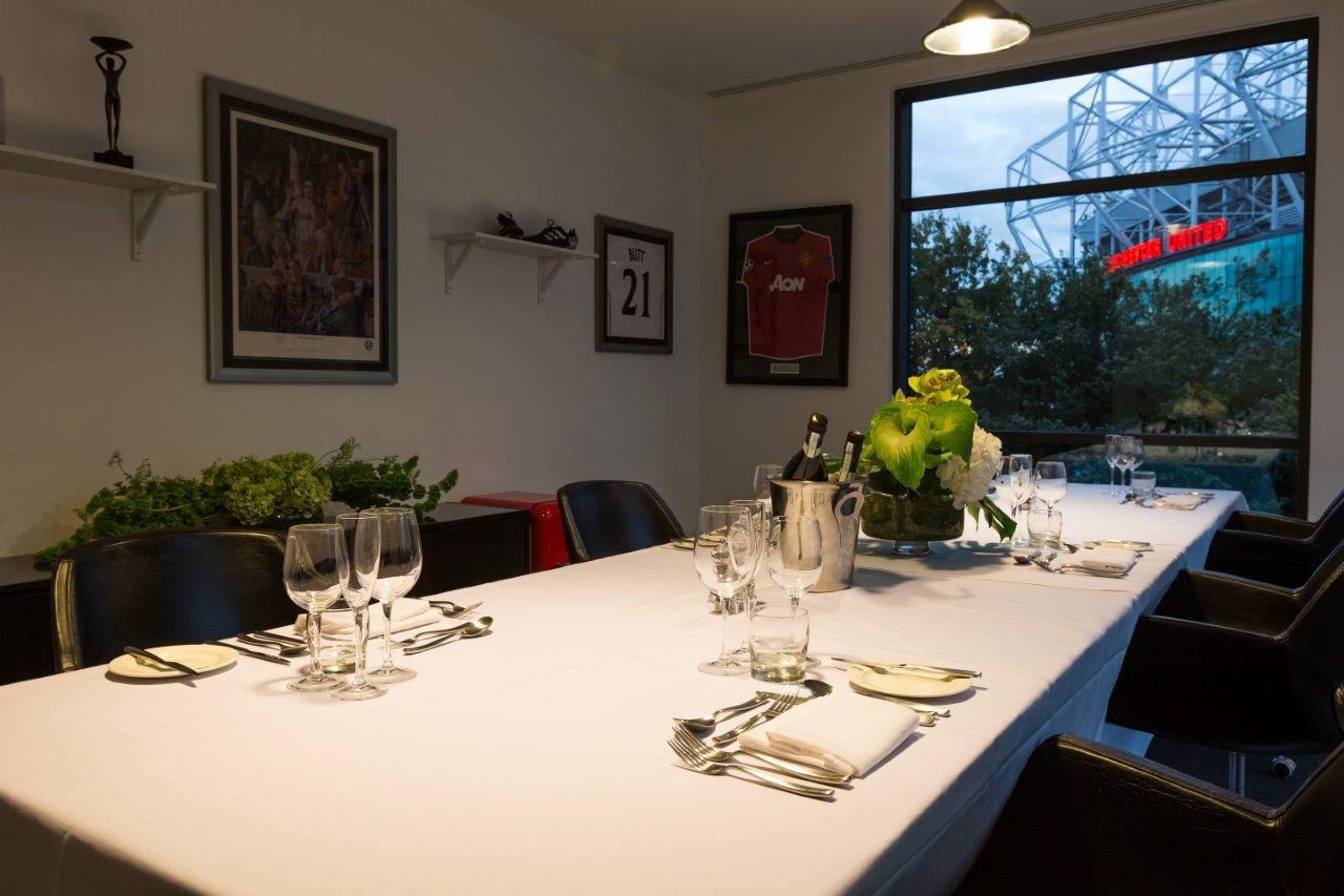 Modern meeting space at Hotel Football, featuring elegant table setup for intimate gatherings.