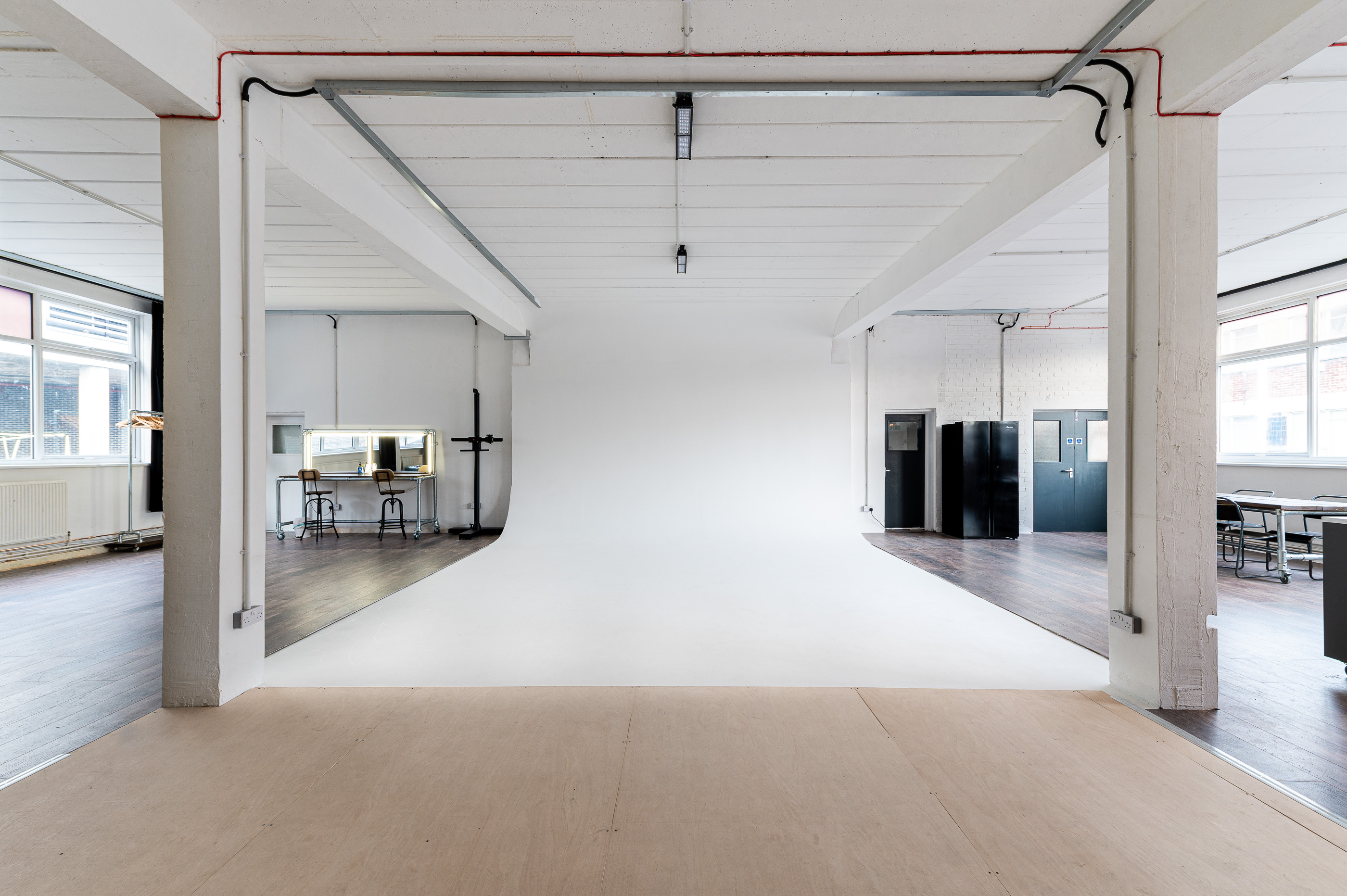 Versatile event space with minimalist backdrop for workshops and photoshoots.