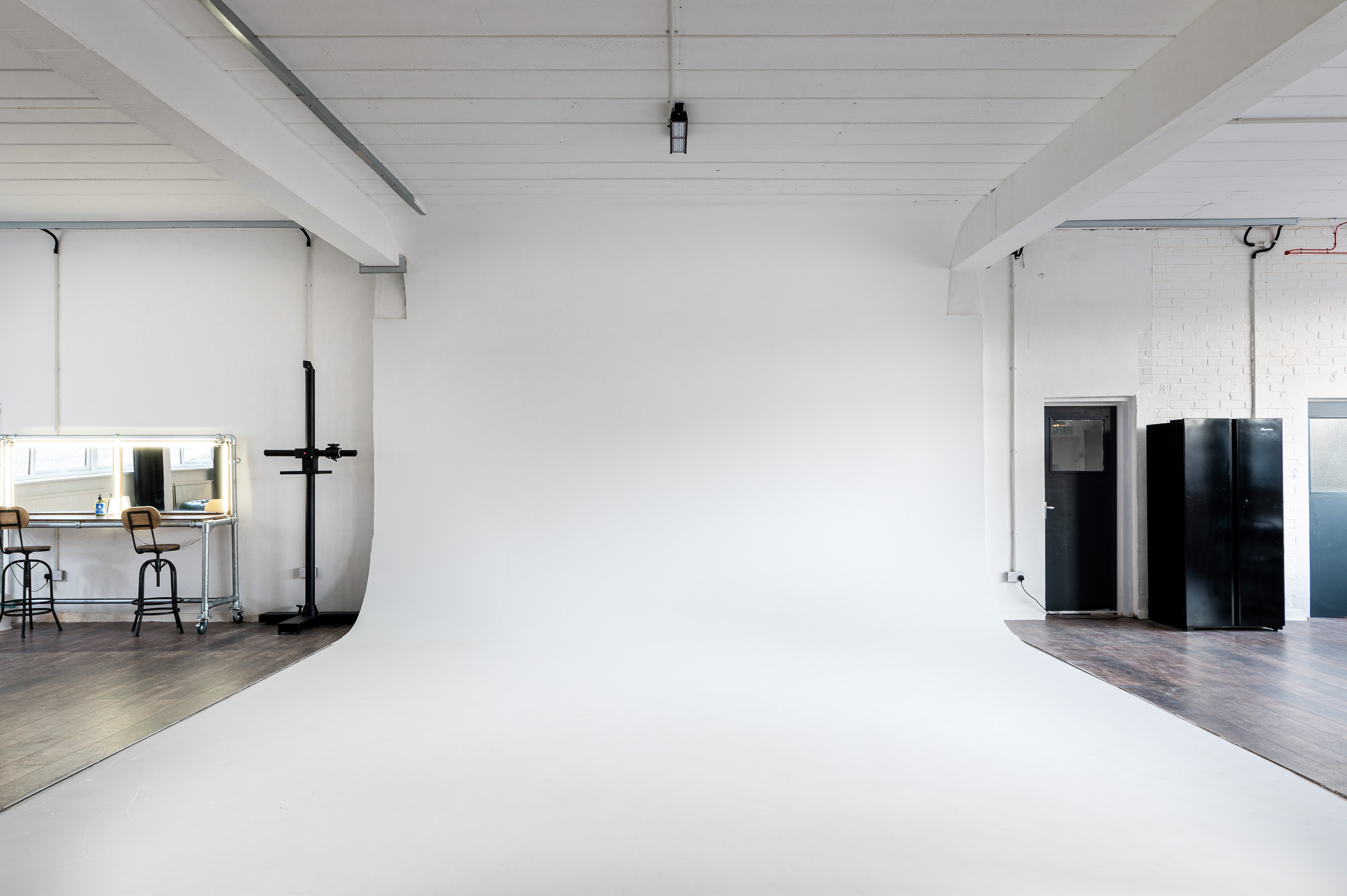 Versatile event space with clean white backdrop for presentations and photo shoots.