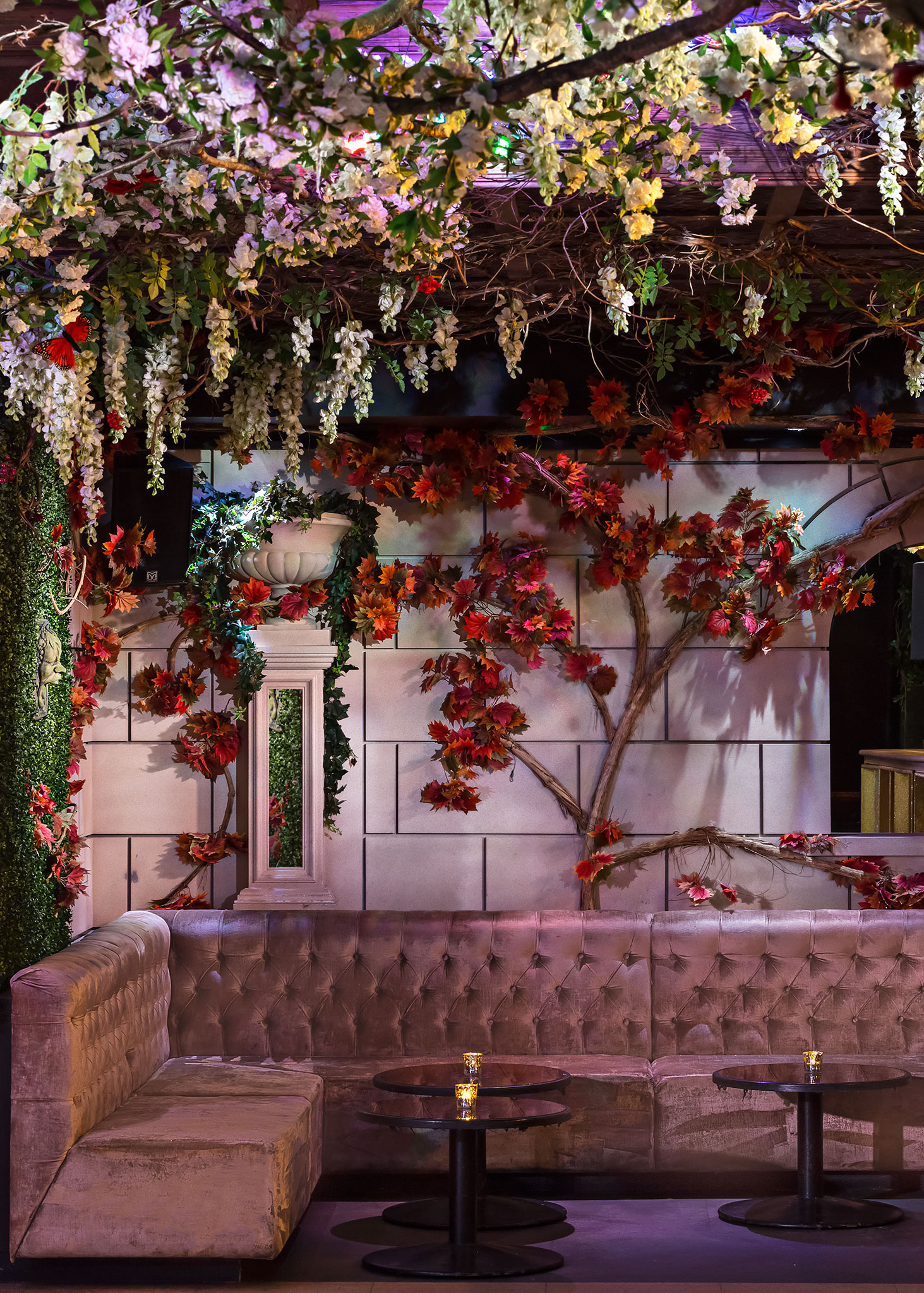 Event space at The Cuckoo Club with faux stone walls and autumn decor for gatherings.