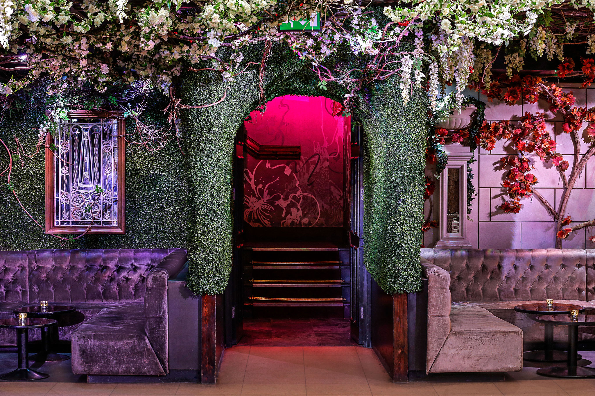 Stylish Cuckoo Club entrance with lush greenery, ideal for events and gatherings.