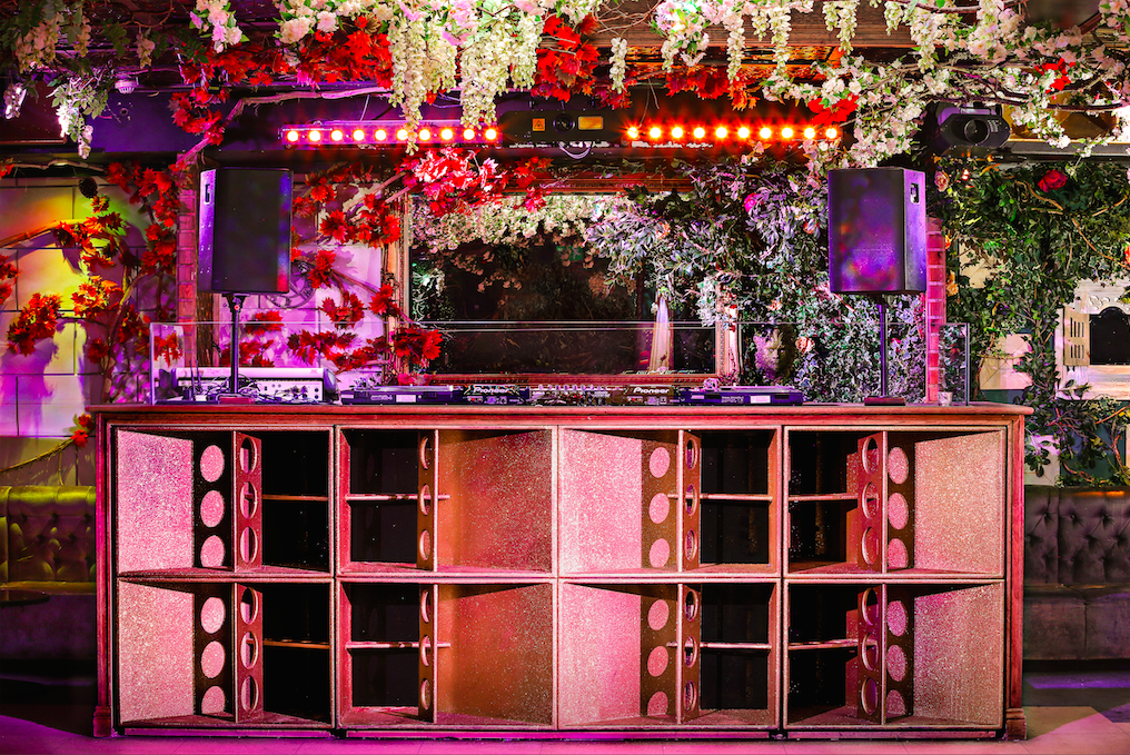 Vibrant Cuckoo Club event space with floral DJ booth, perfect for parties and celebrations.