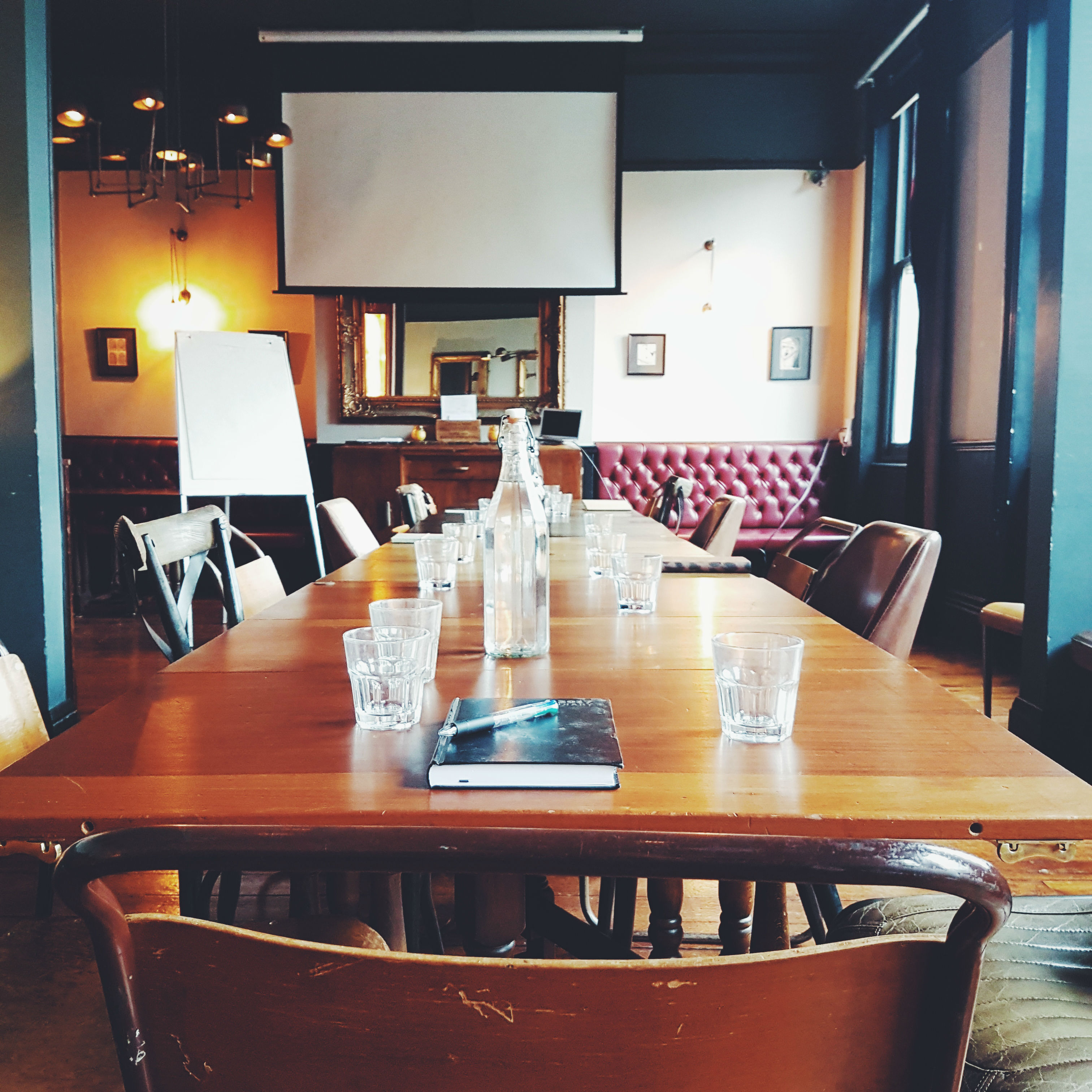 Meeting space at The Snug, featuring a long wooden table for collaboration and brainstorming.