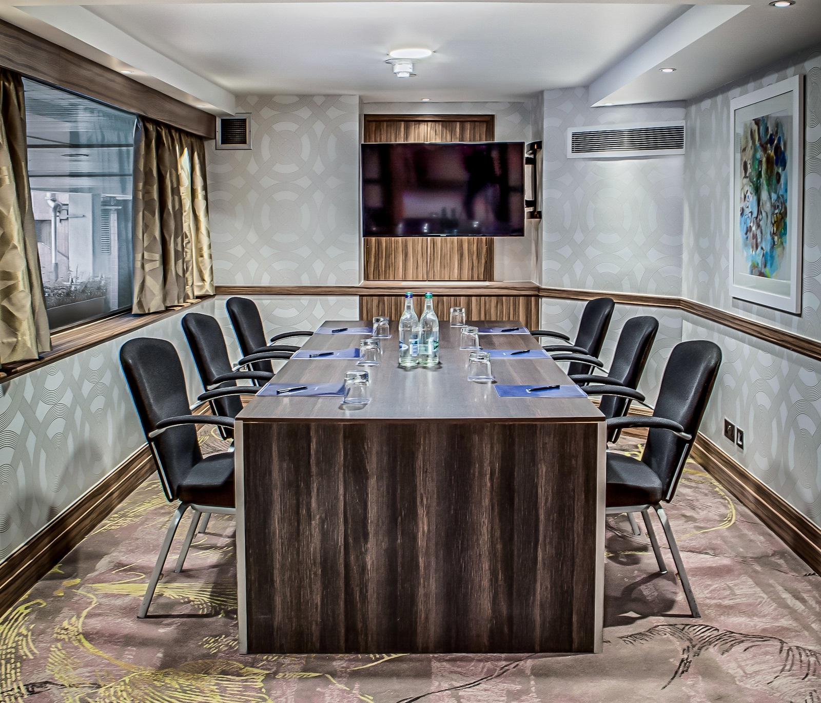Boardroom 2 at Hilton London Kensington with central table, ideal for meetings and presentations.