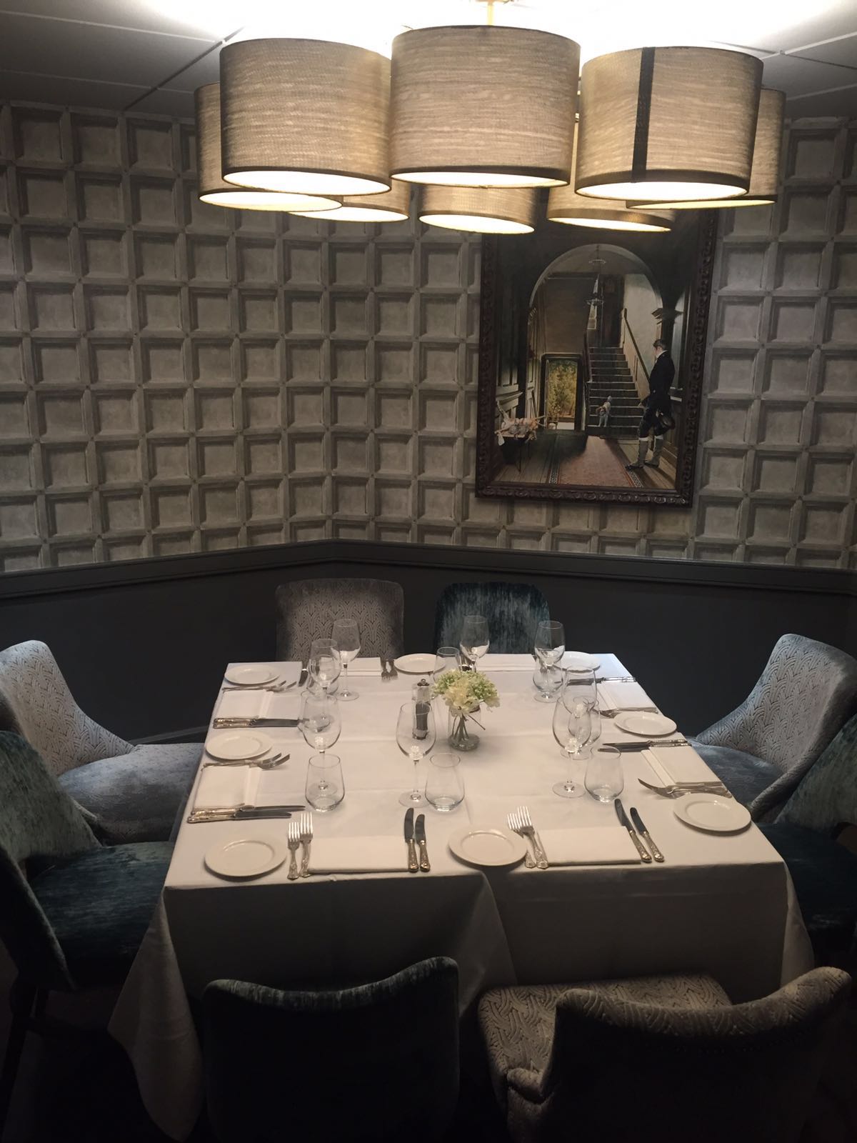 Elegant private dining room with plush seating, ideal for intimate events and meetings.