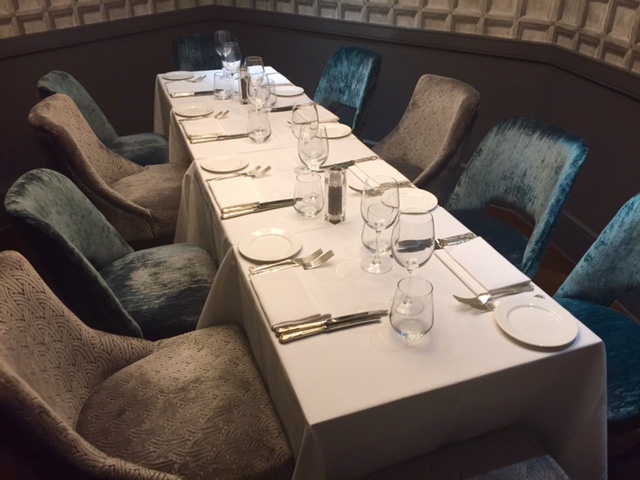 Private dining room with elegant table setting for intimate meetings and events.
