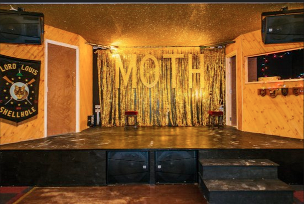 Main Hall at Moth Club with stage, golden curtain, ideal for events and performances.