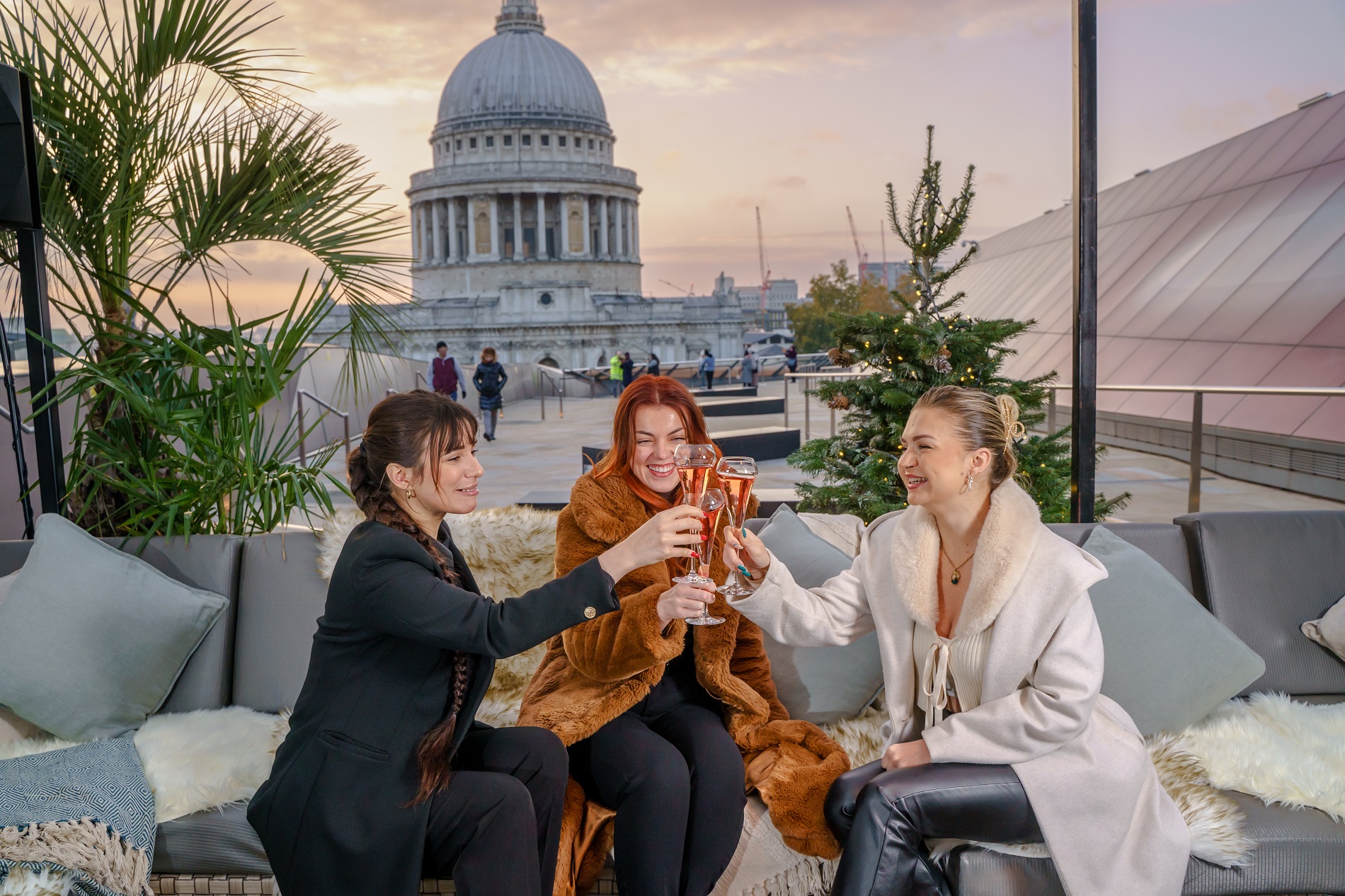 Stylish rooftop gathering at Upper Terrace, St. Paul's Cathedral backdrop, ideal for events.