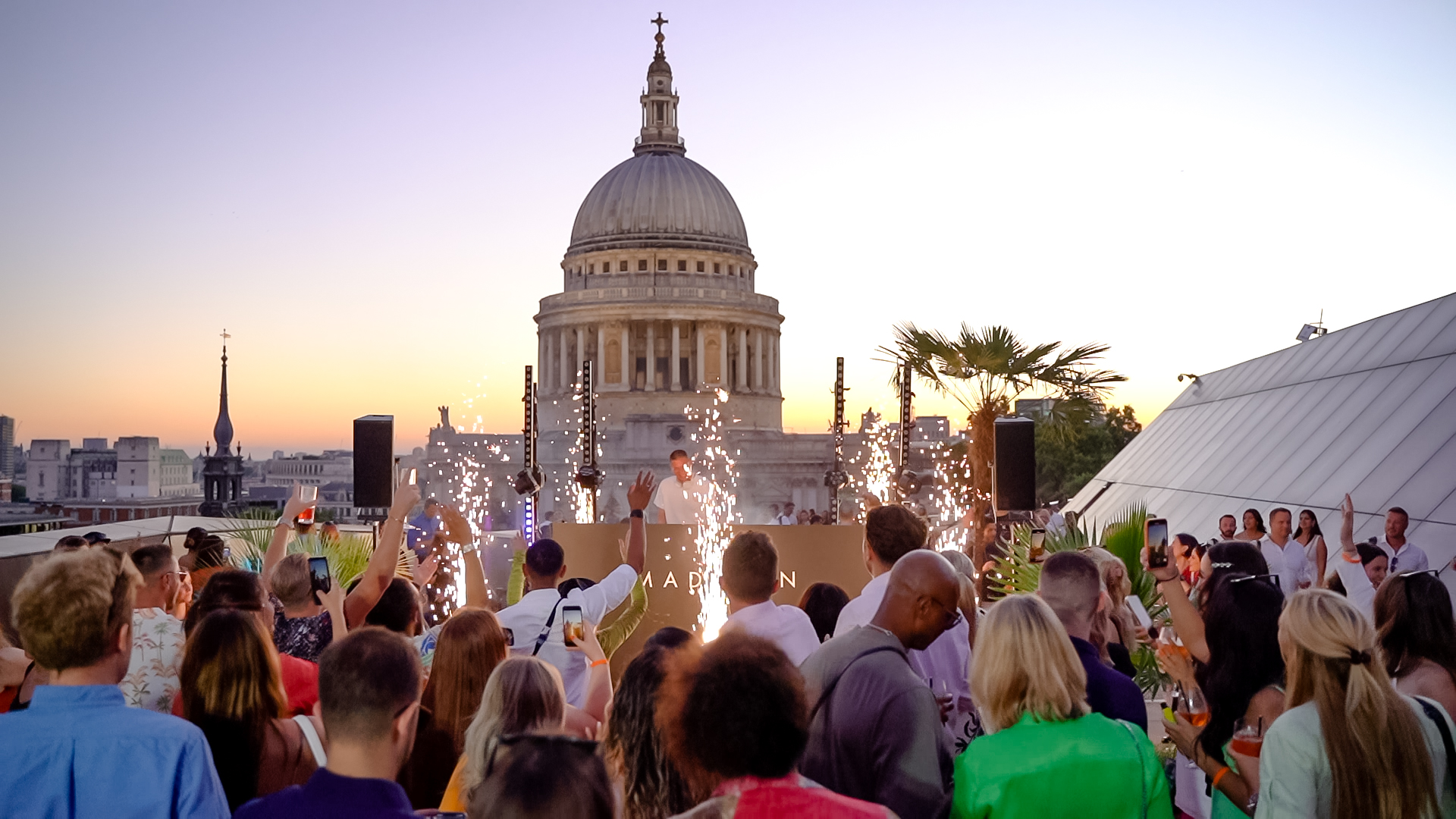 Vibrant rooftop event at Upper Terrace, Madison with St. Paul's Cathedral backdrop and sparklers.