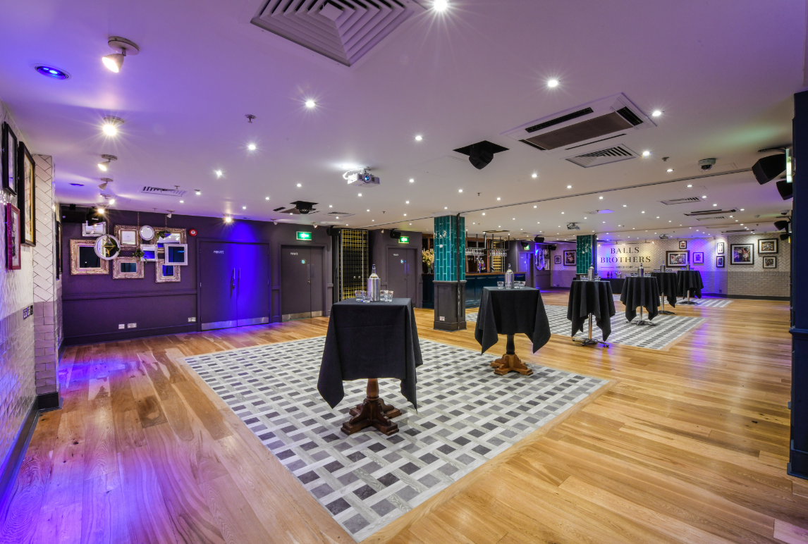 Minster Suite event space with polished wooden floors, ideal for networking and receptions.