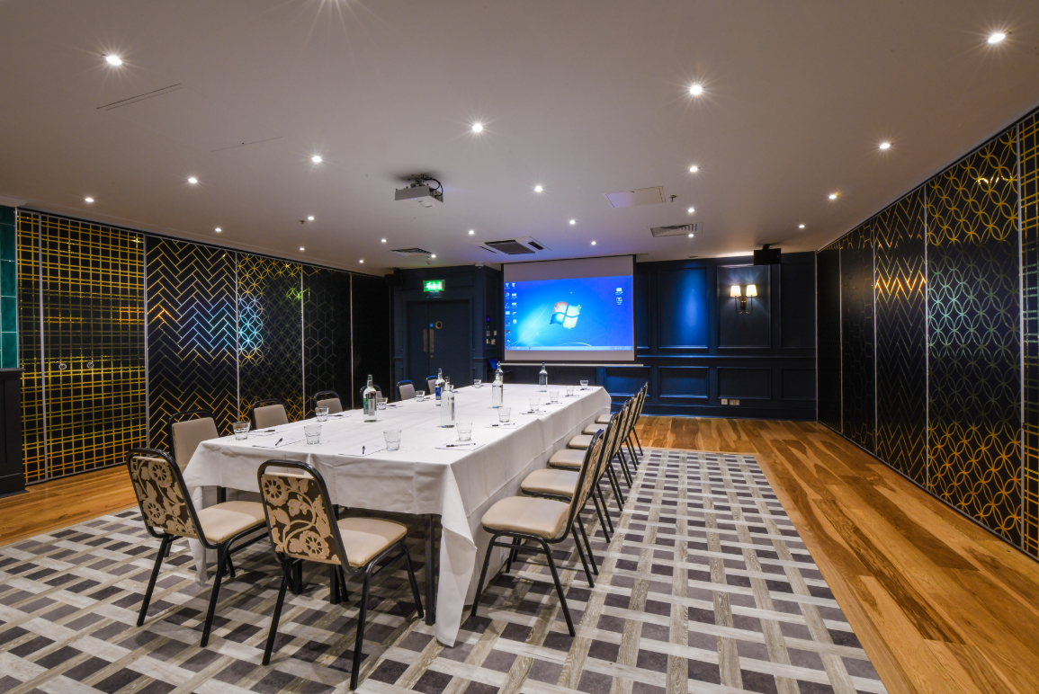 Minster Suite meeting room with long table, ideal for professional gatherings and presentations.