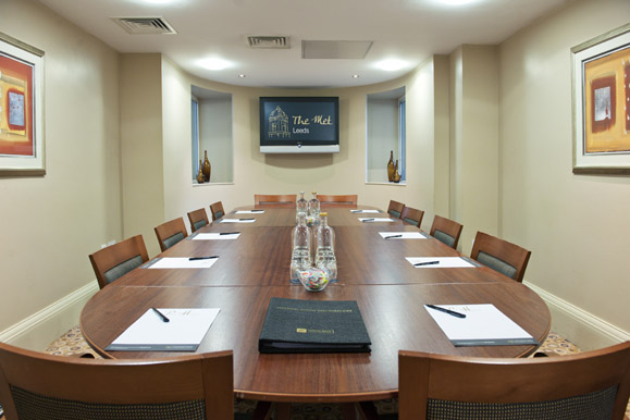 Met 12 meeting room at The Met Hotel with oval table, ideal for professional gatherings.