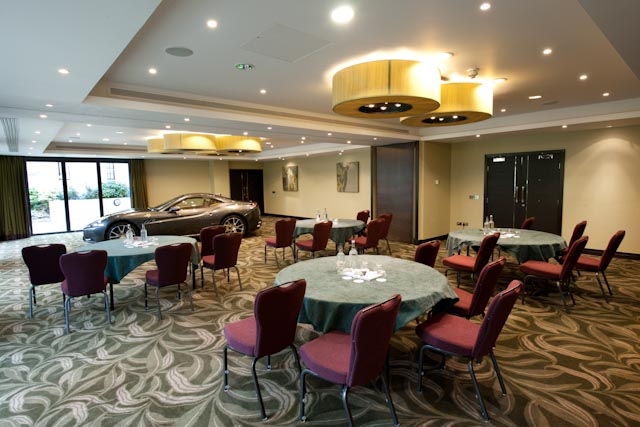 Hurst Castle Suite with round tables, elegant decor for upscale events and meetings.