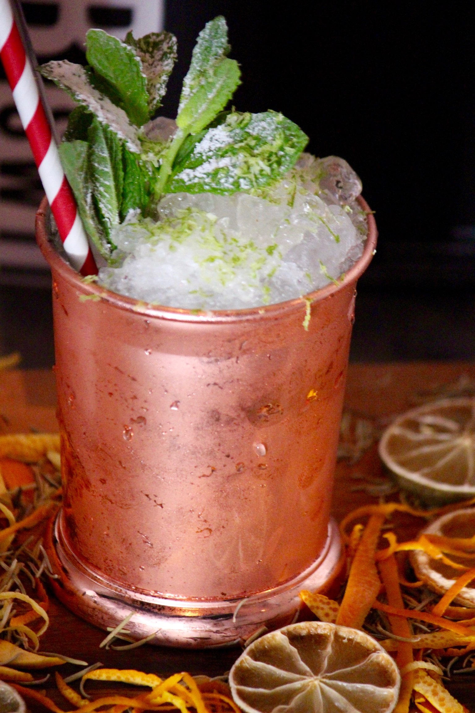 Copper mug cocktail with lime zest, perfect for summer soirées and themed parties.