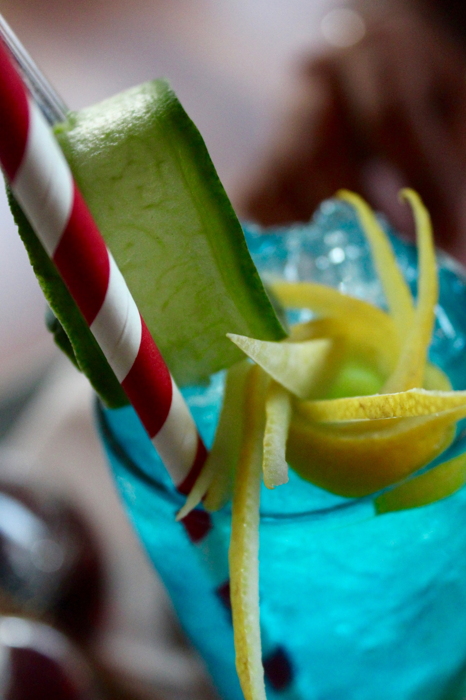 Vibrant cocktail with cucumber and lemon twists for events in Suburb SW11.