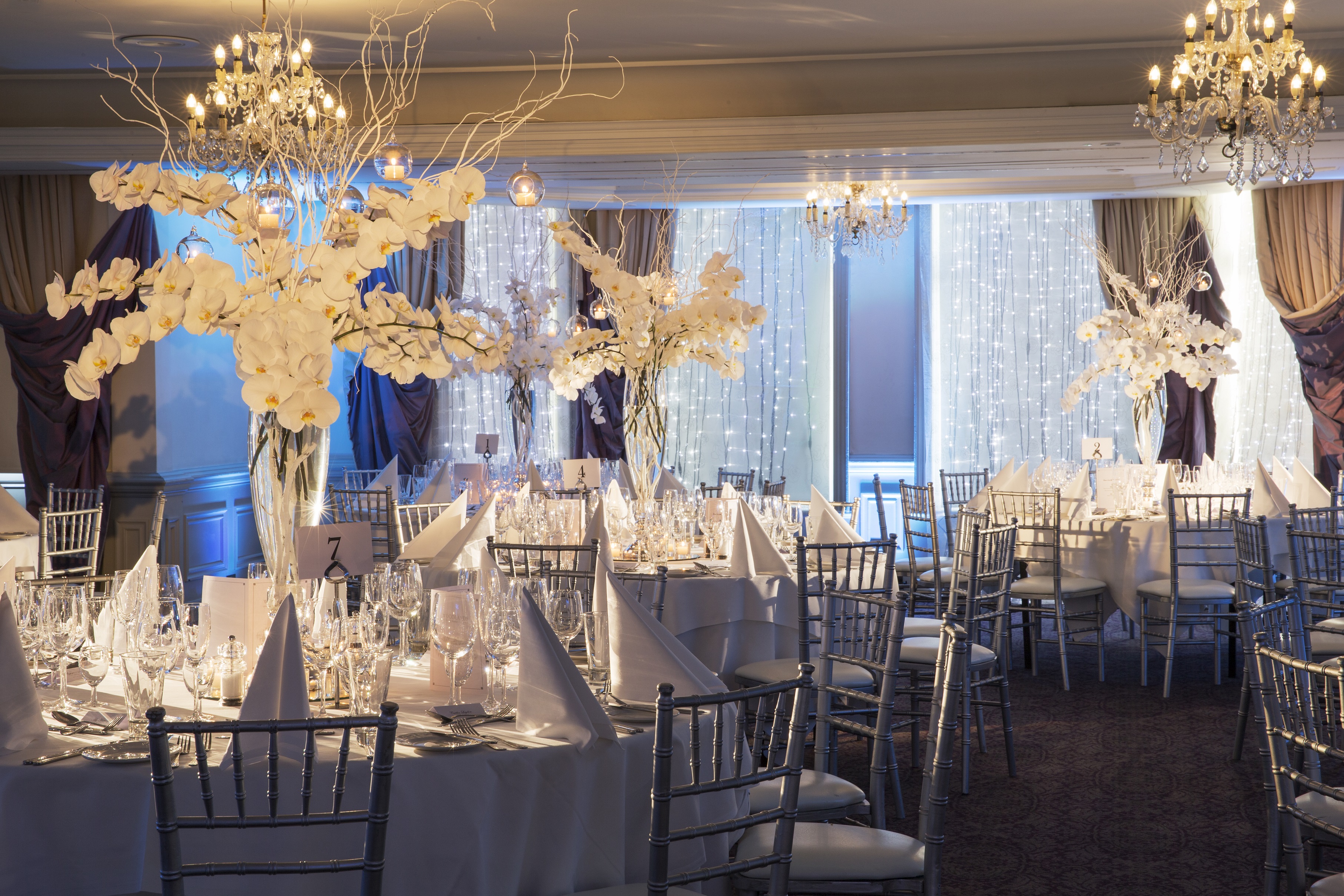 Prince of Wales Suite at Woodlands Park Hotel, elegant wedding venue with white orchids.