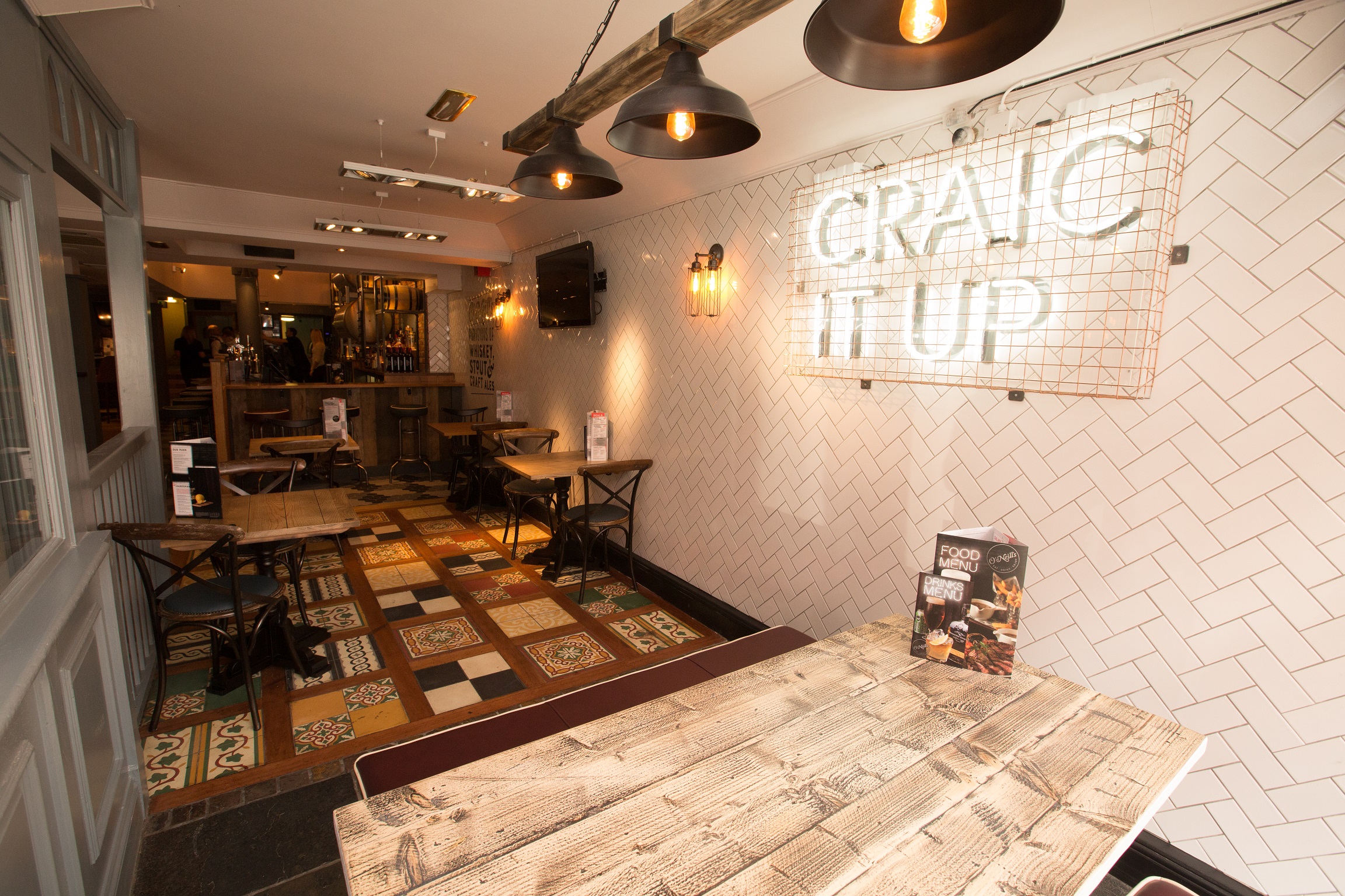 Cozy venue with warm lighting for informal meetings and small events in O'Neill's Wardour Street.