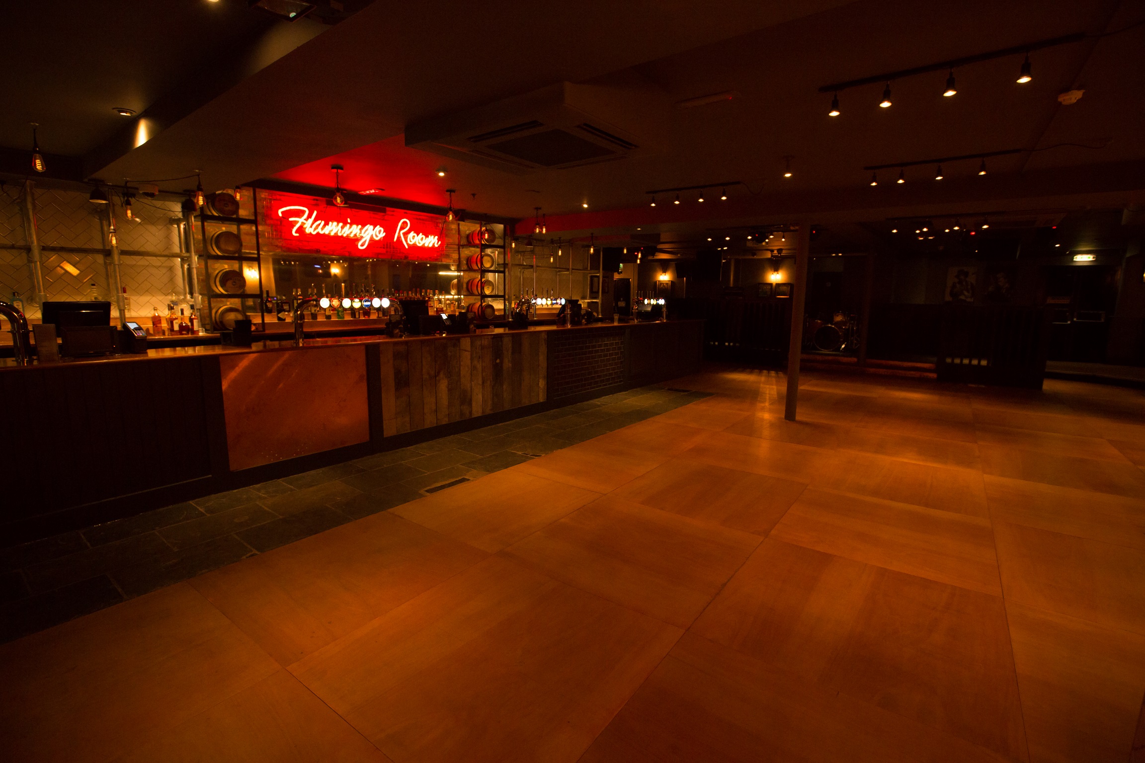 Stylish event space at O'Neill's Wardour Street with modern bar and neon signage.