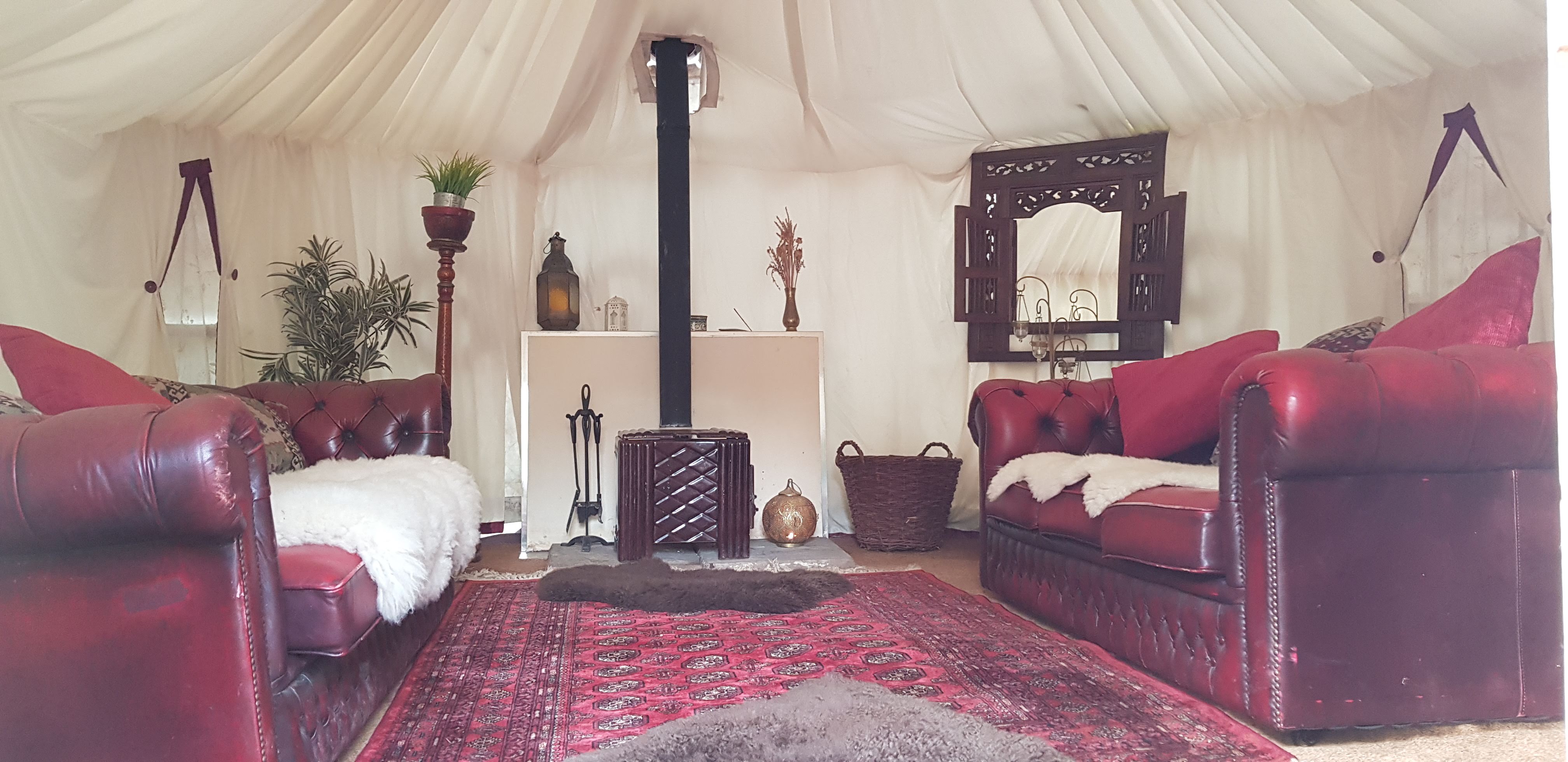 Cozy yurt-style wedding venue with plush seating for intimate events and gatherings.
