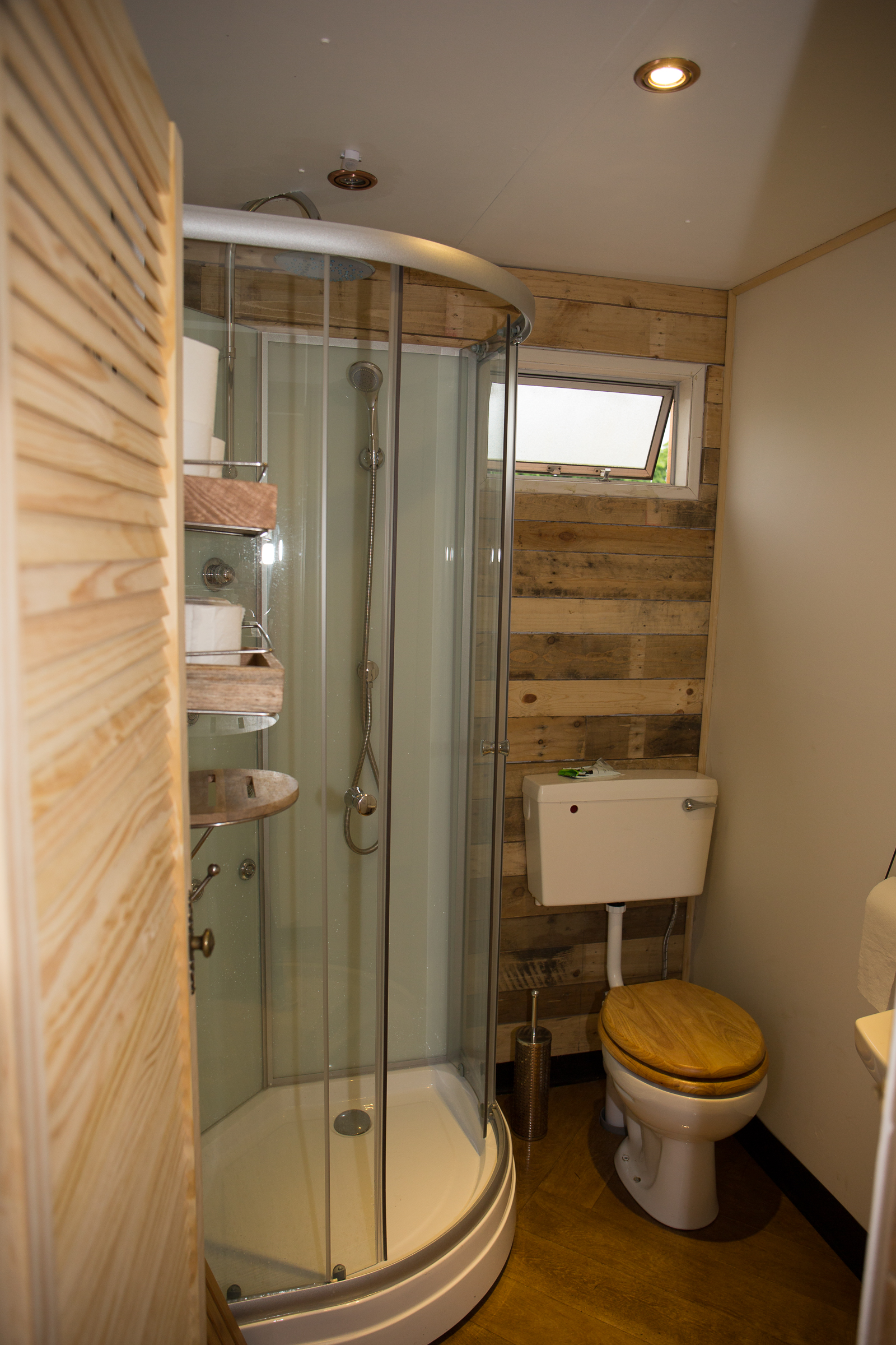 Compact bathroom with modern shower in Plush Tents Glamping wedding venue.
