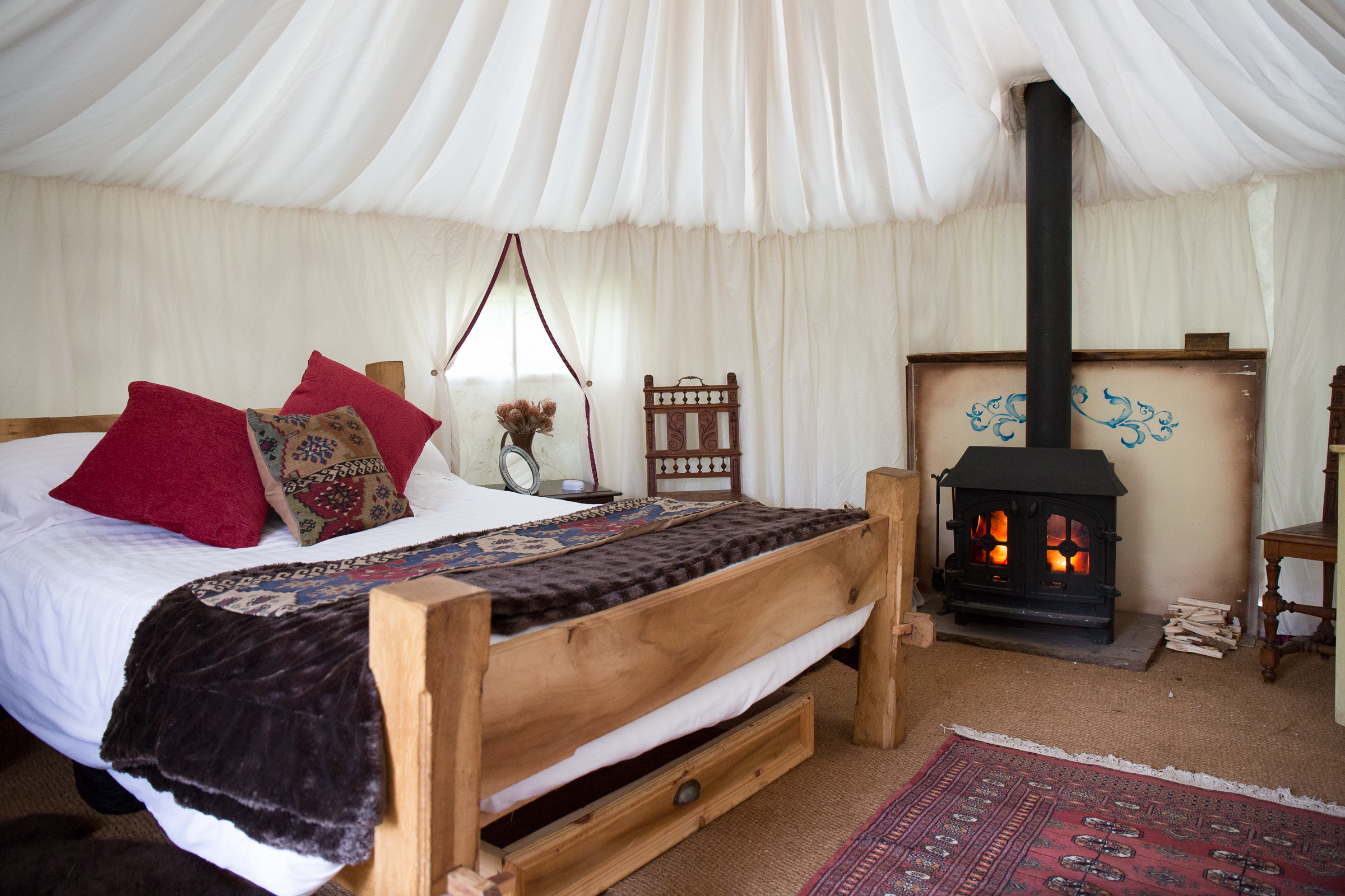 Cozy yurt venue with wood stove for unique weddings and retreats.