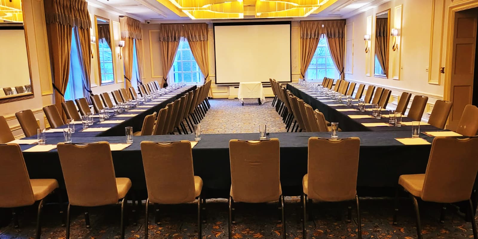 Johnnie Walker U-shape meeting room with AV screen for corporate events and professional seminars.