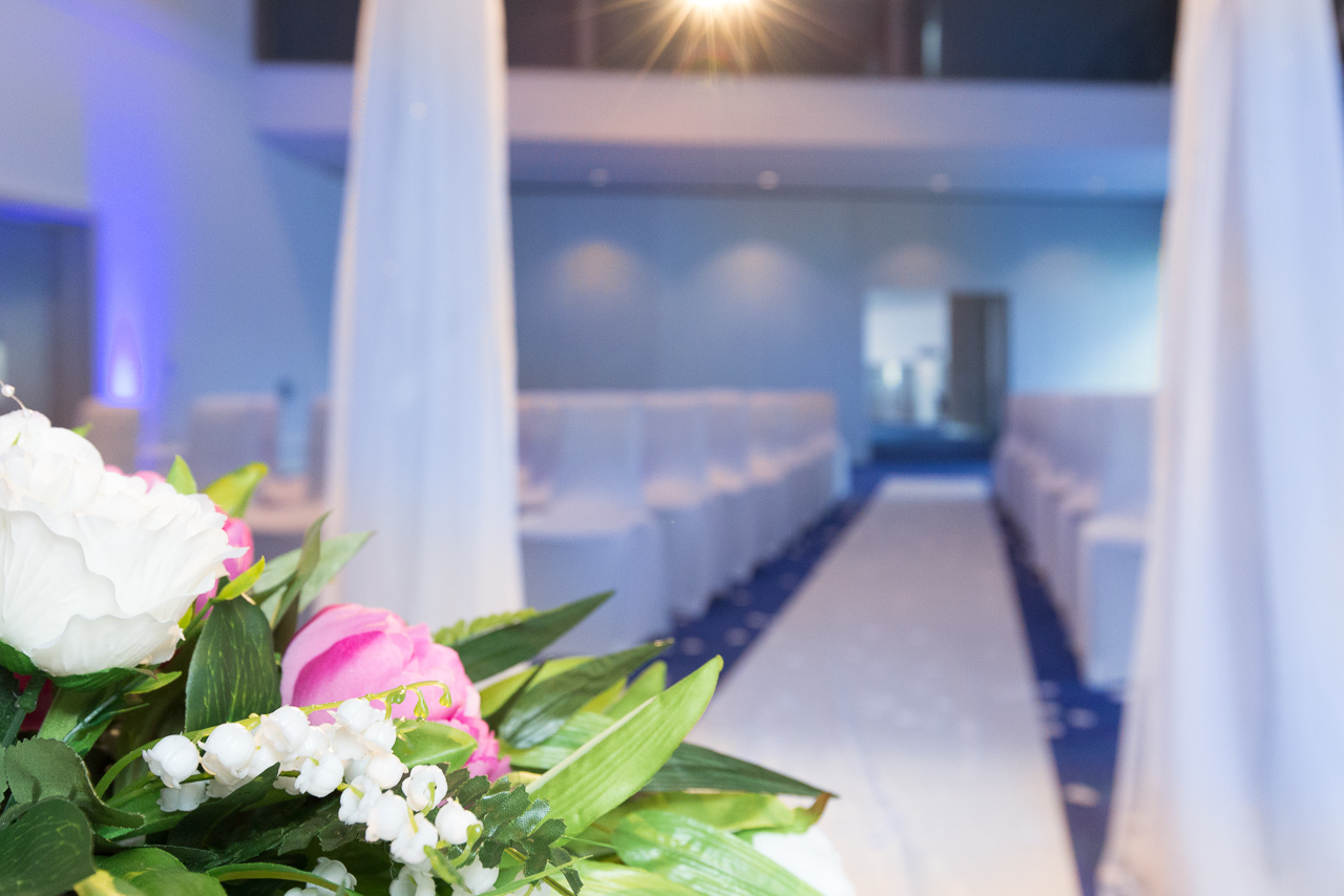 Barbirolli Room wedding venue with elegant floral arrangements and white chairs.