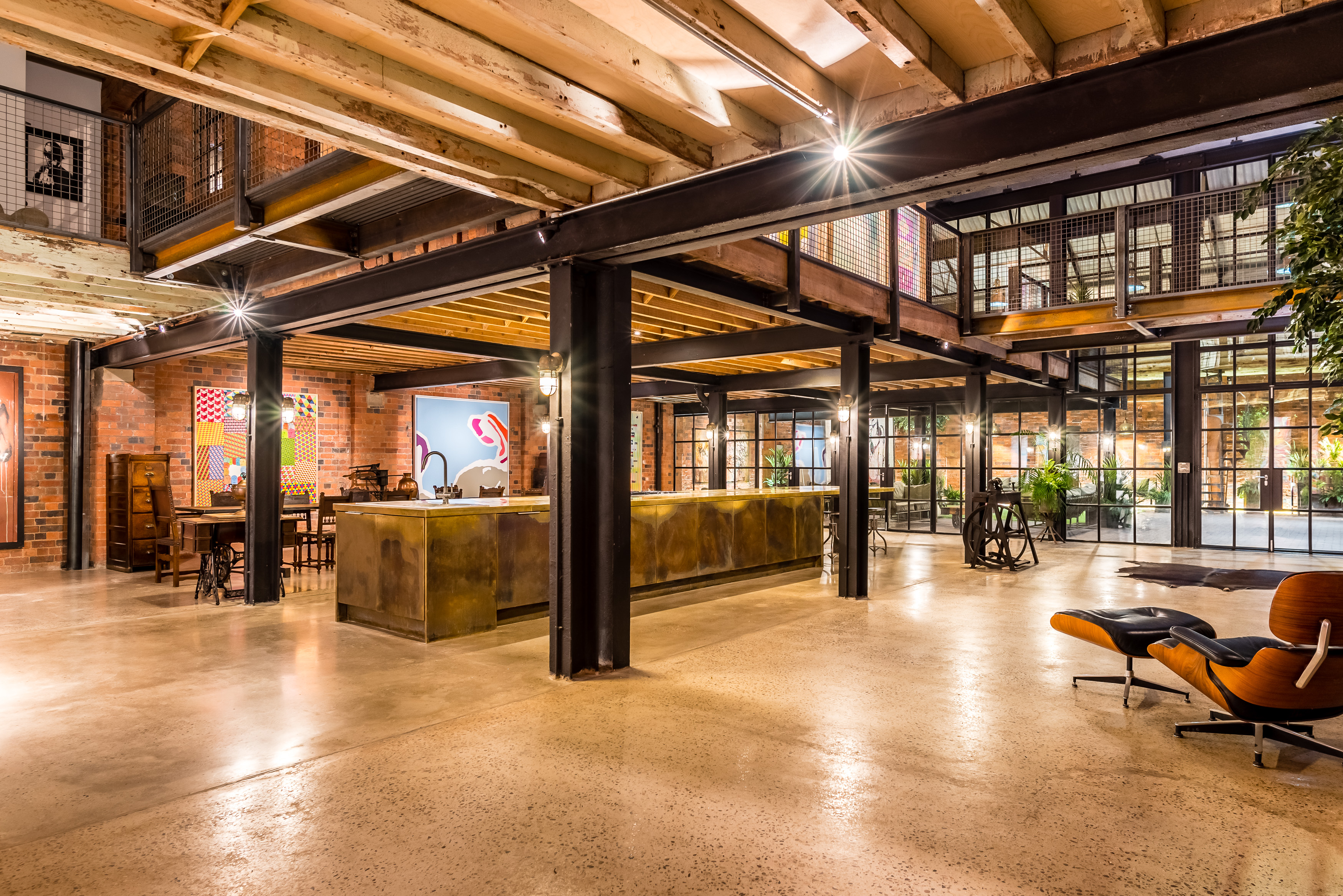 Modern industrial event space with exposed brick, ideal for meetings and gatherings.