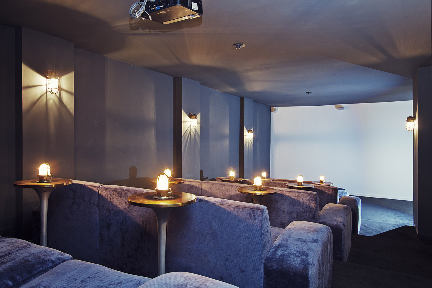 Intimate event space with plush seating, ideal for gatherings and presentations.