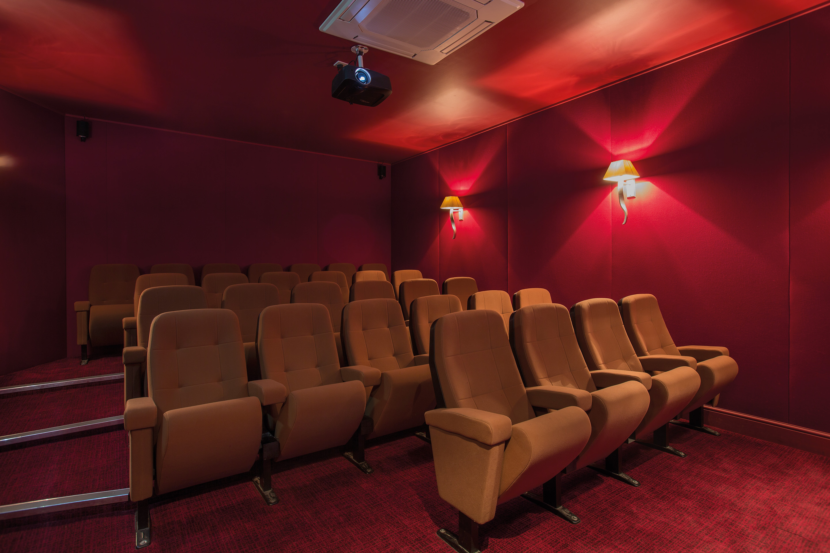 Intimate theater space with plush seating at Fawsley Hall for corporate meetings and screenings.