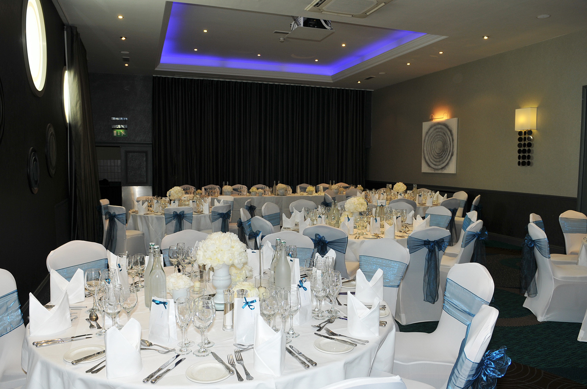 Grand Suite banquet setup with elegant tables, perfect for weddings and corporate events.