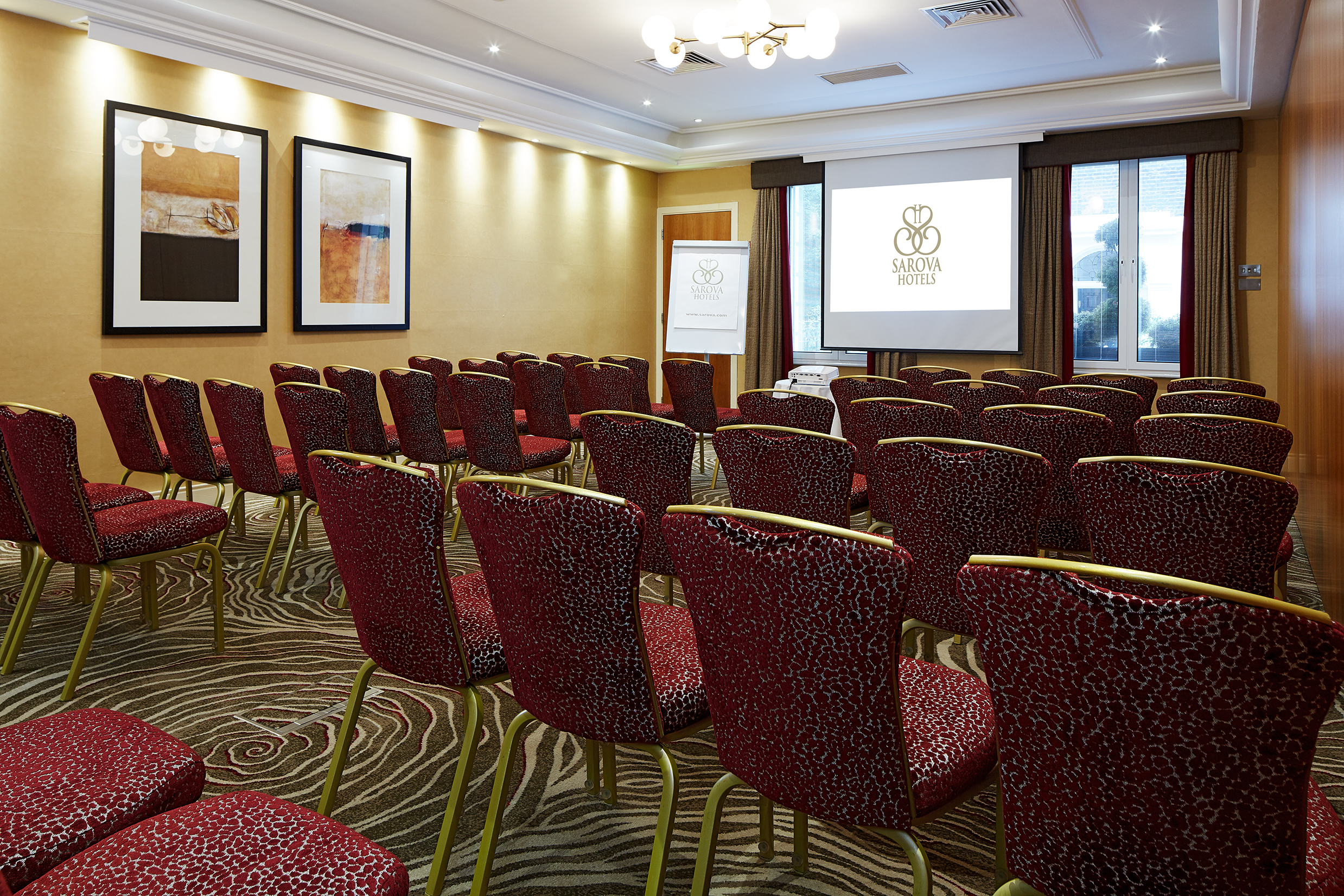 Edward Suite meeting room with plush chairs, ideal for corporate presentations and events.