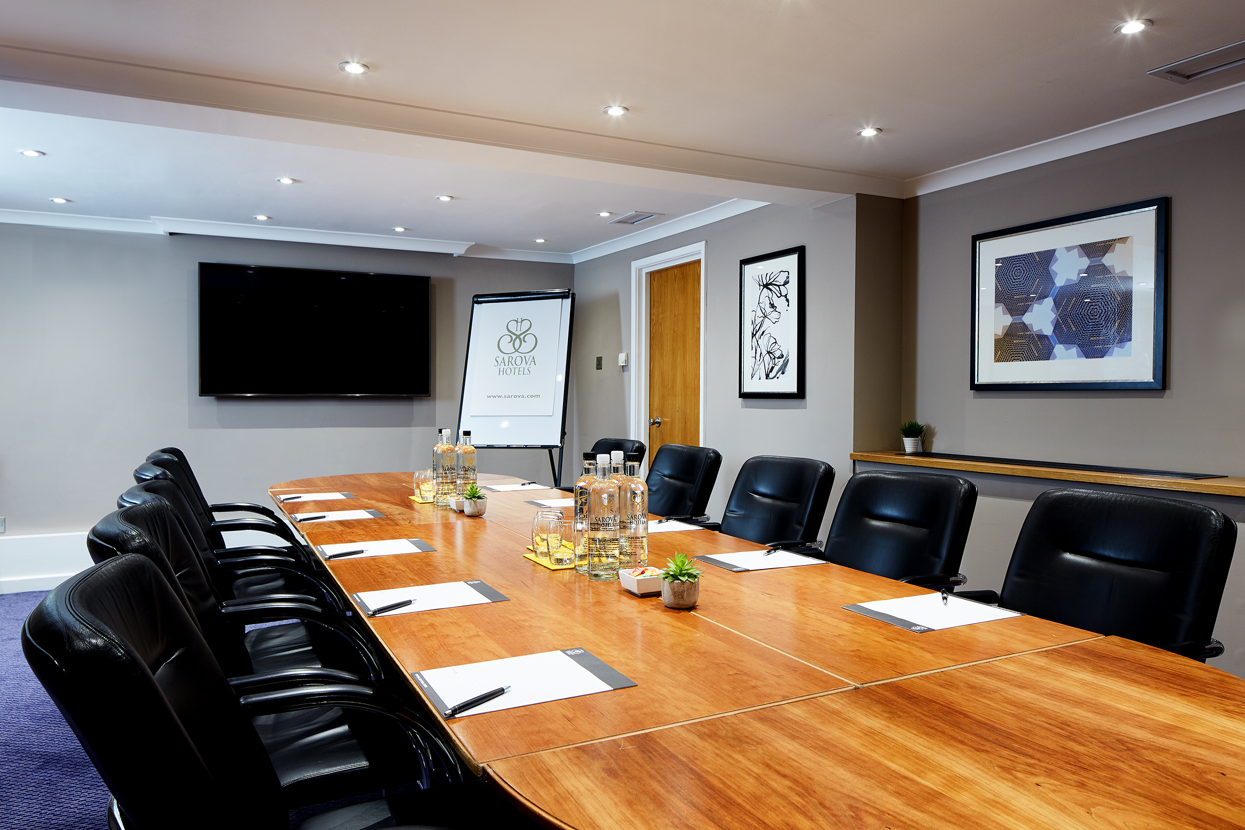 Boardroom at The Rembrandt with sleek table, ideal for corporate meetings and workshops.