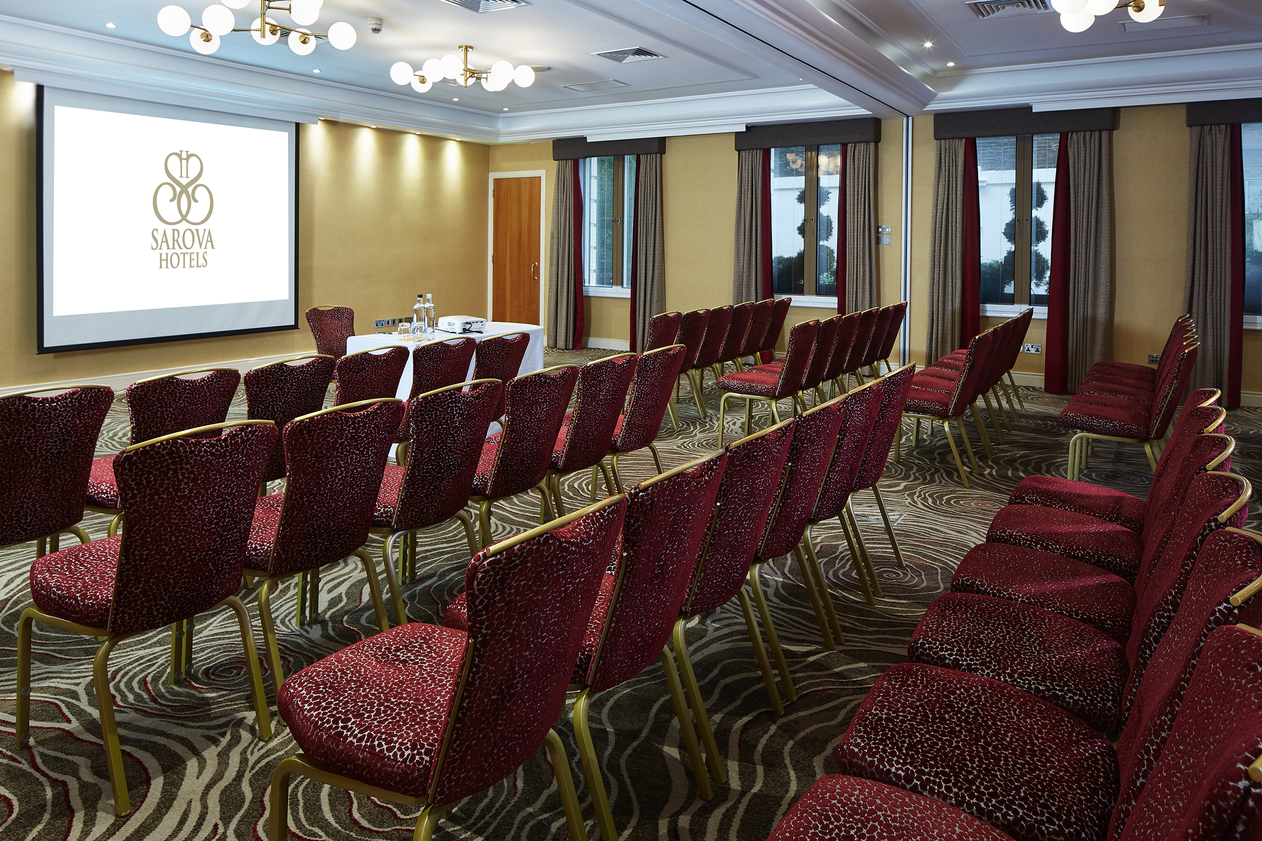 Edward and Charles Suites meeting room with plush chairs for professional events.