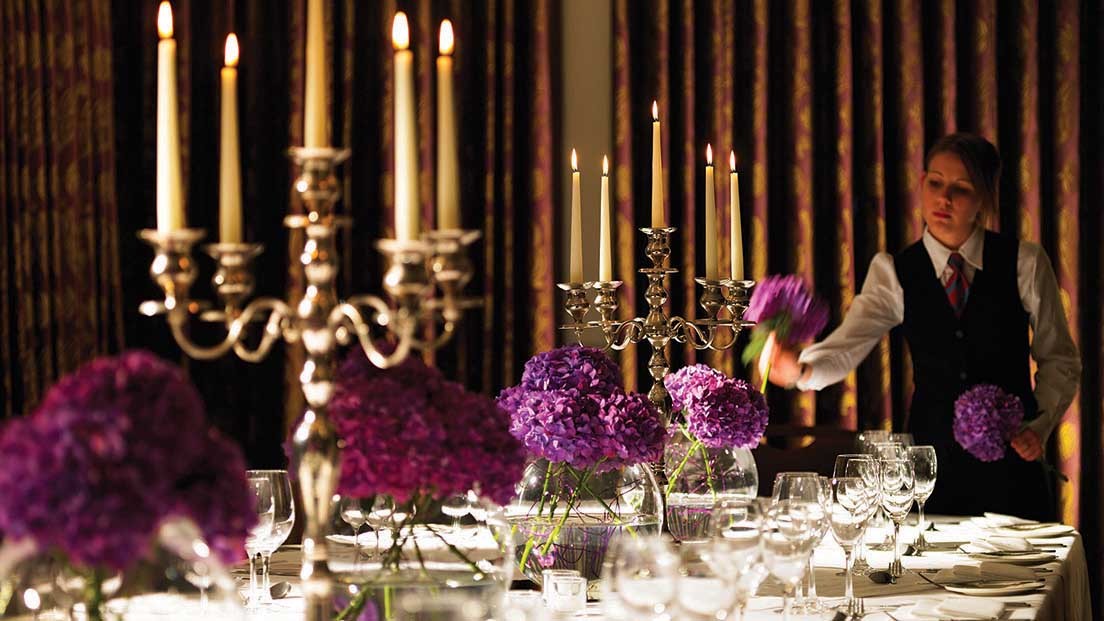 Elegant dining setup with floral centerpieces at Woodlands Park Hotel for upscale events.