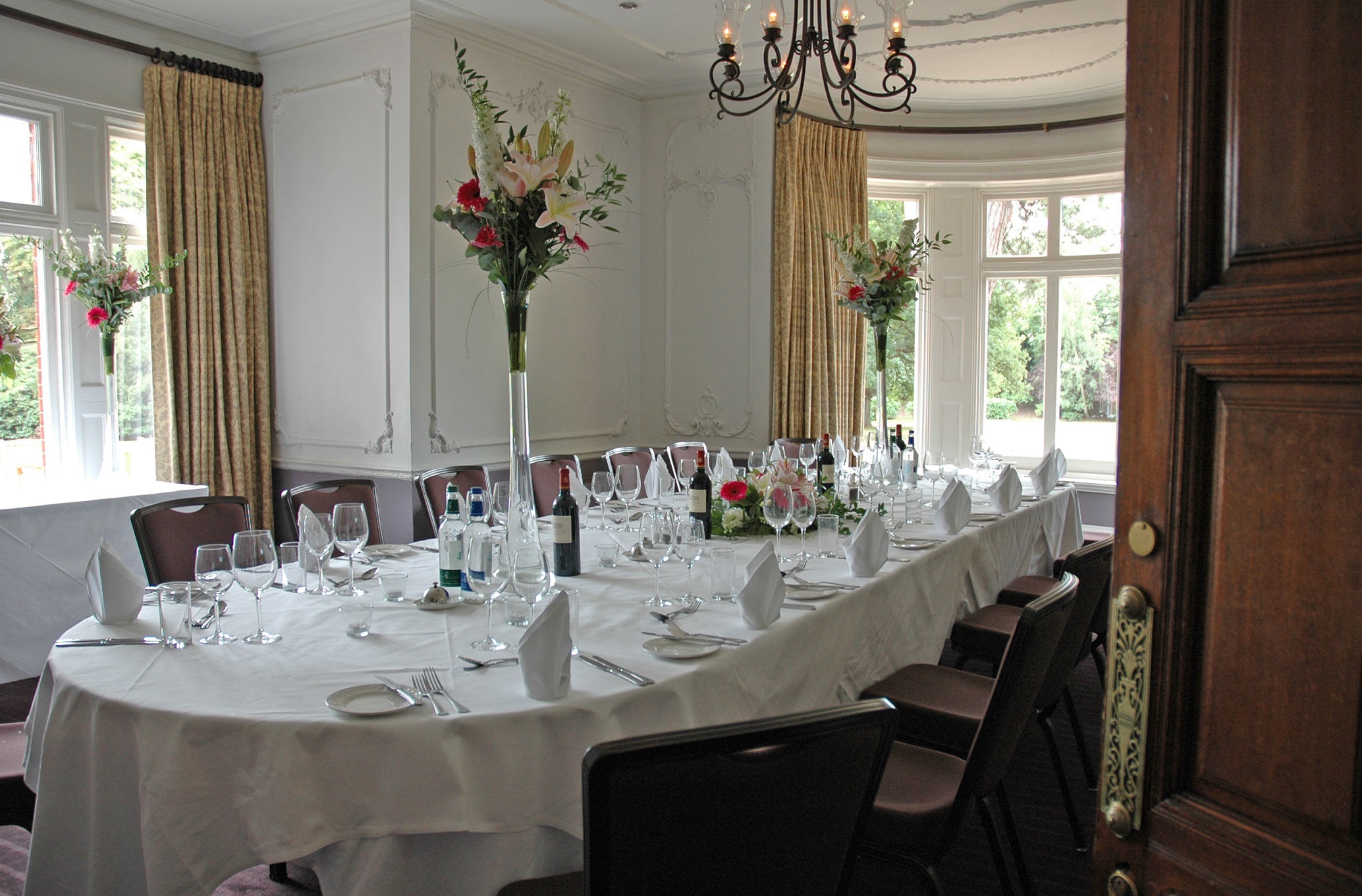 Elegant meeting room at Woodlands Park Hotel with oval table, ideal for corporate events.