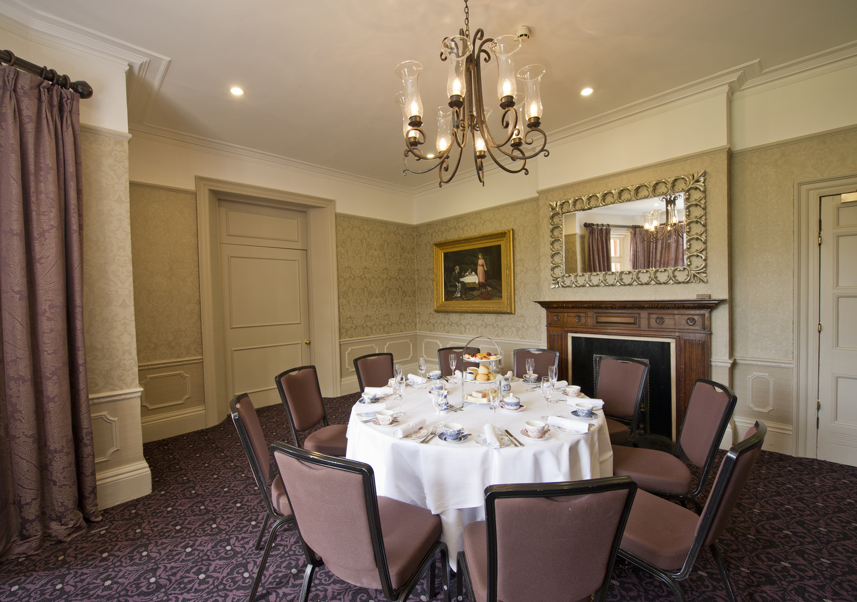 Elegant meeting space with round table for upscale events at Woodlands Park Hotel.