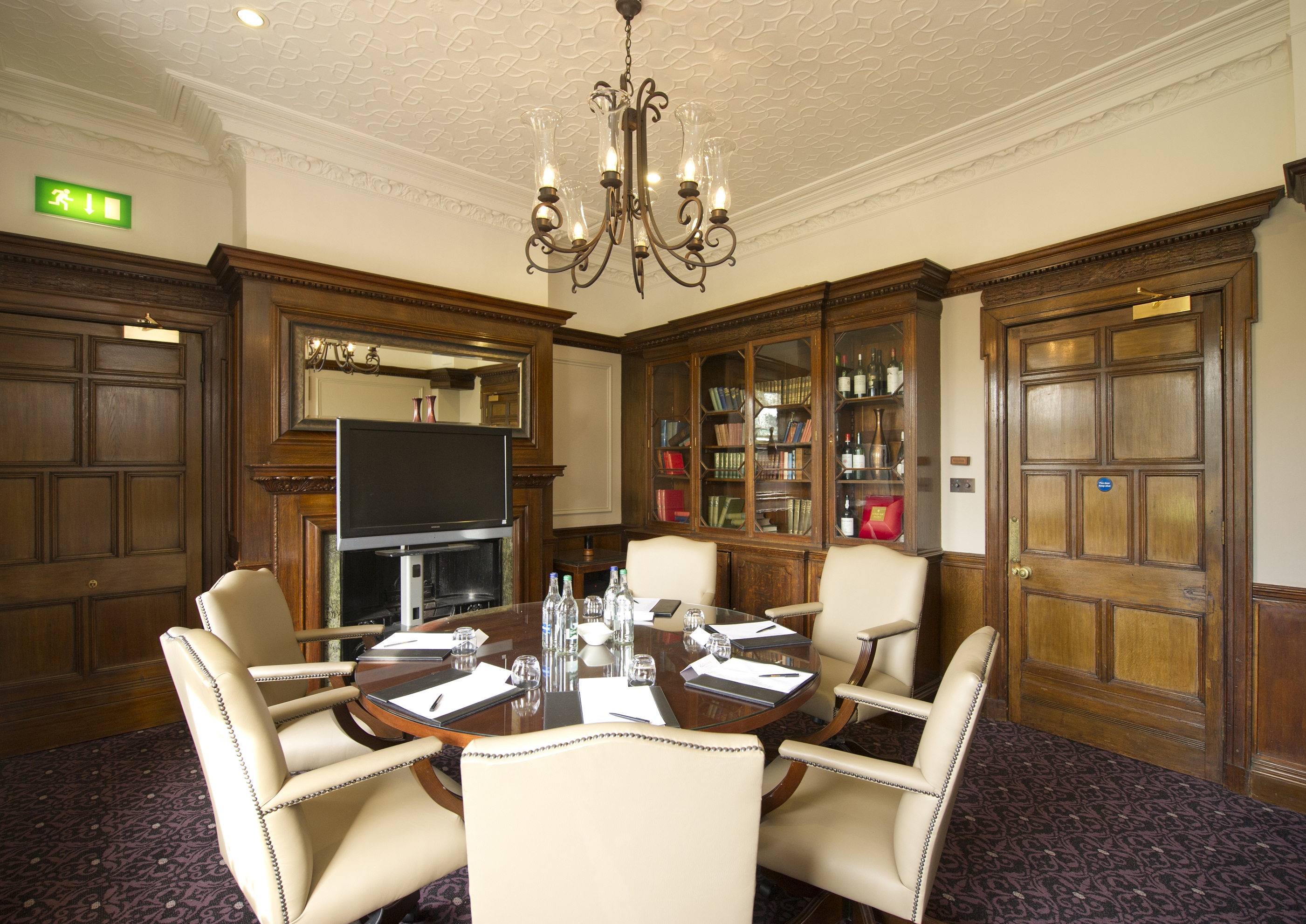 Boardroom at Woodlands Park Hotel with elegant wooden paneling for executive meetings.