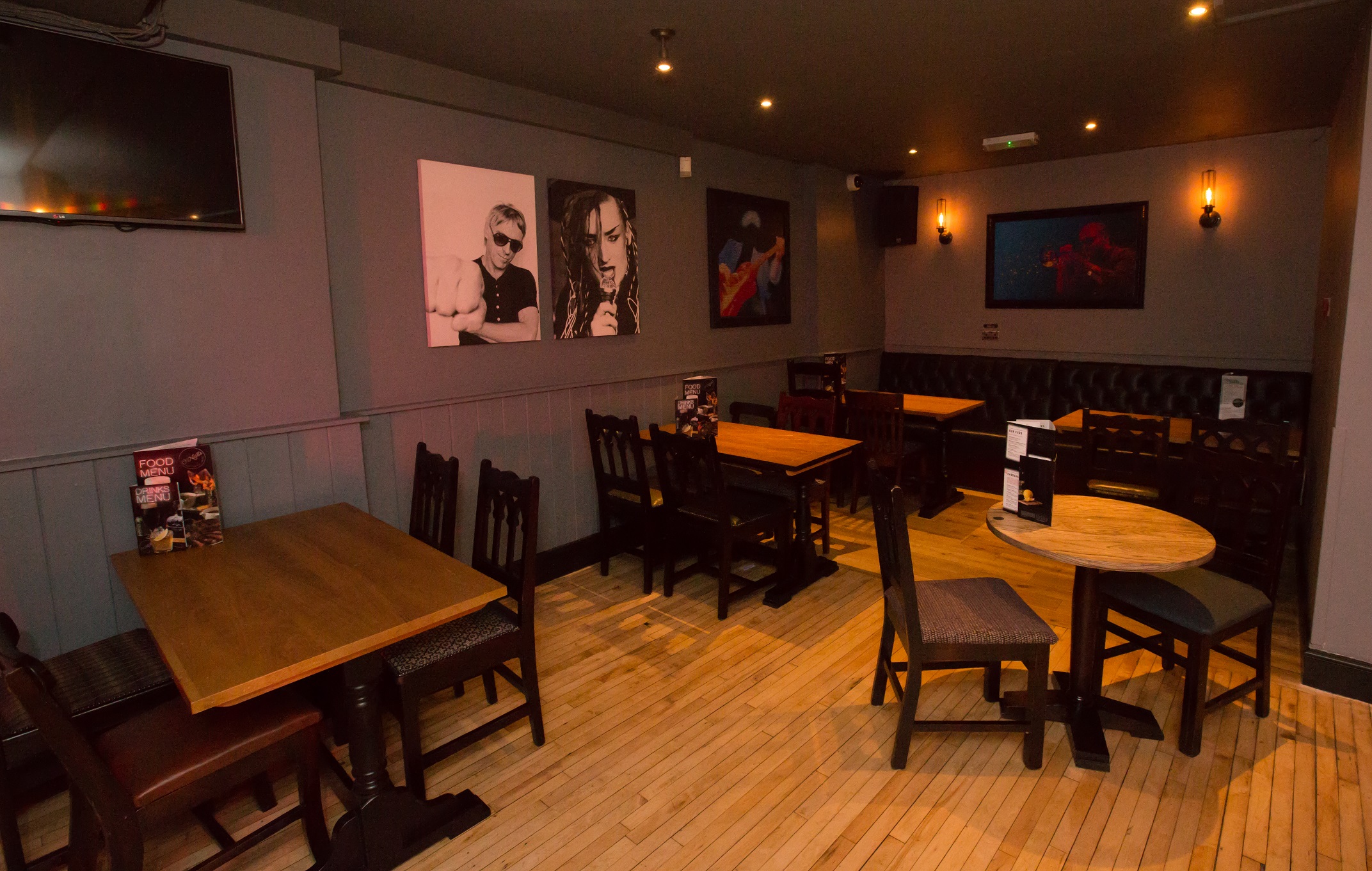 Versatile event space with wooden tables, perfect for networking and small gatherings.