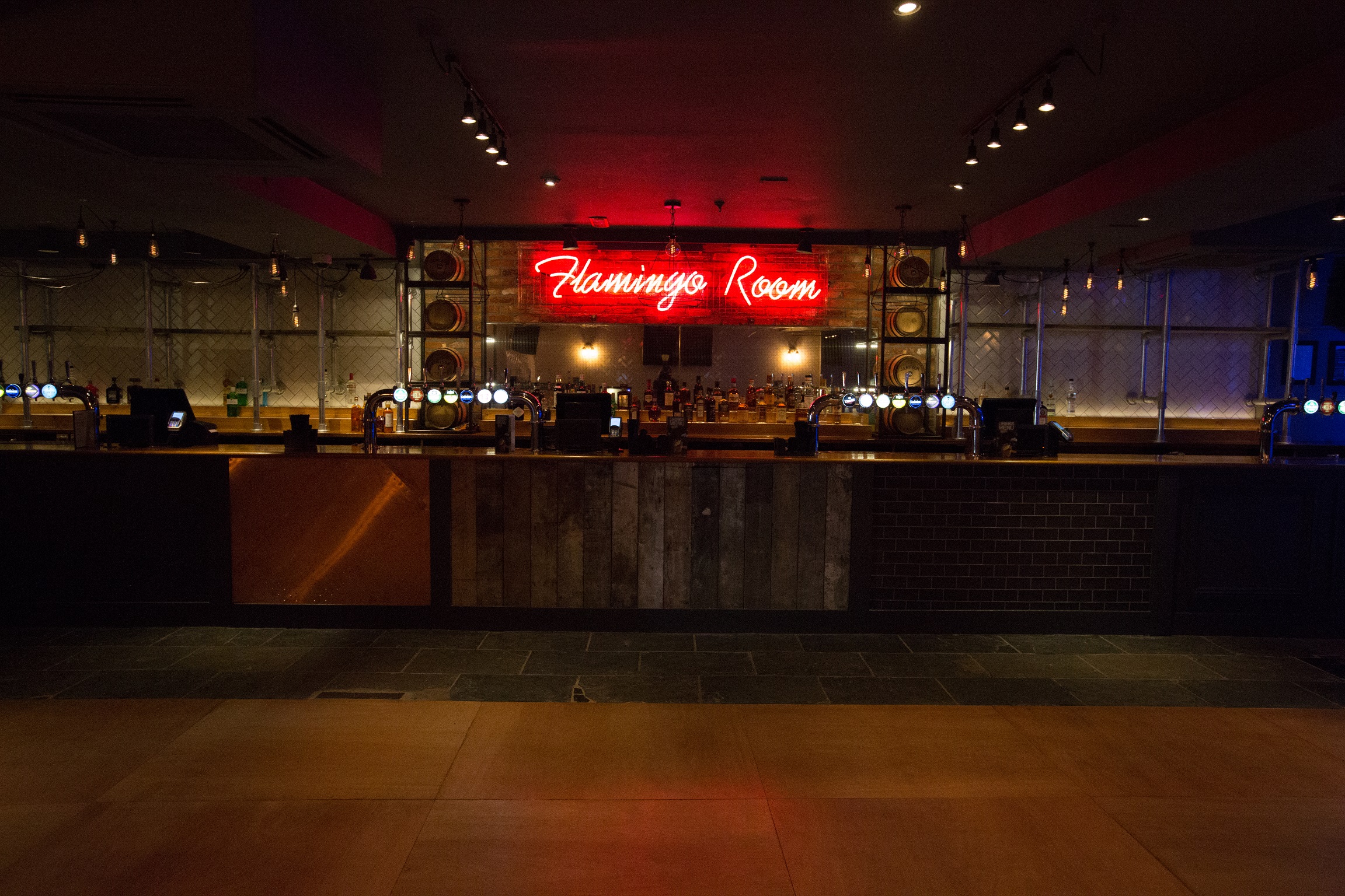 Flamingo Room bar with neon sign, ideal for networking events and social gatherings.