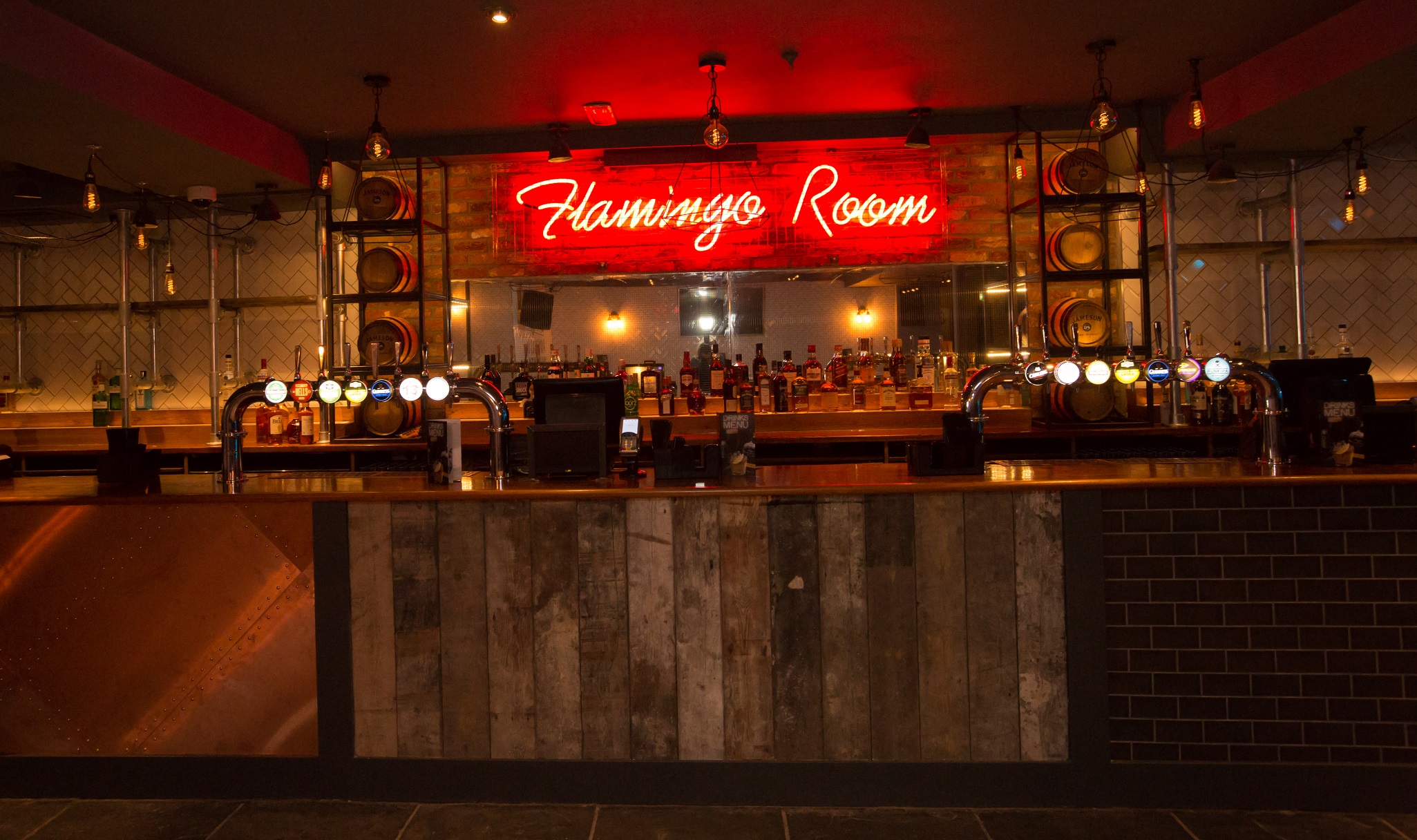 Flamingo Room bar with neon sign, ideal for cocktail receptions and social gatherings.