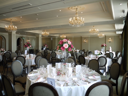 Elegant banquet hall with floral centerpieces at L'Horizon Beach Hotel for upscale events.