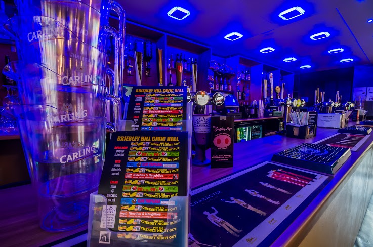 Vibrant bar area with blue lighting for networking events at Brierley Hill Civic Hall.