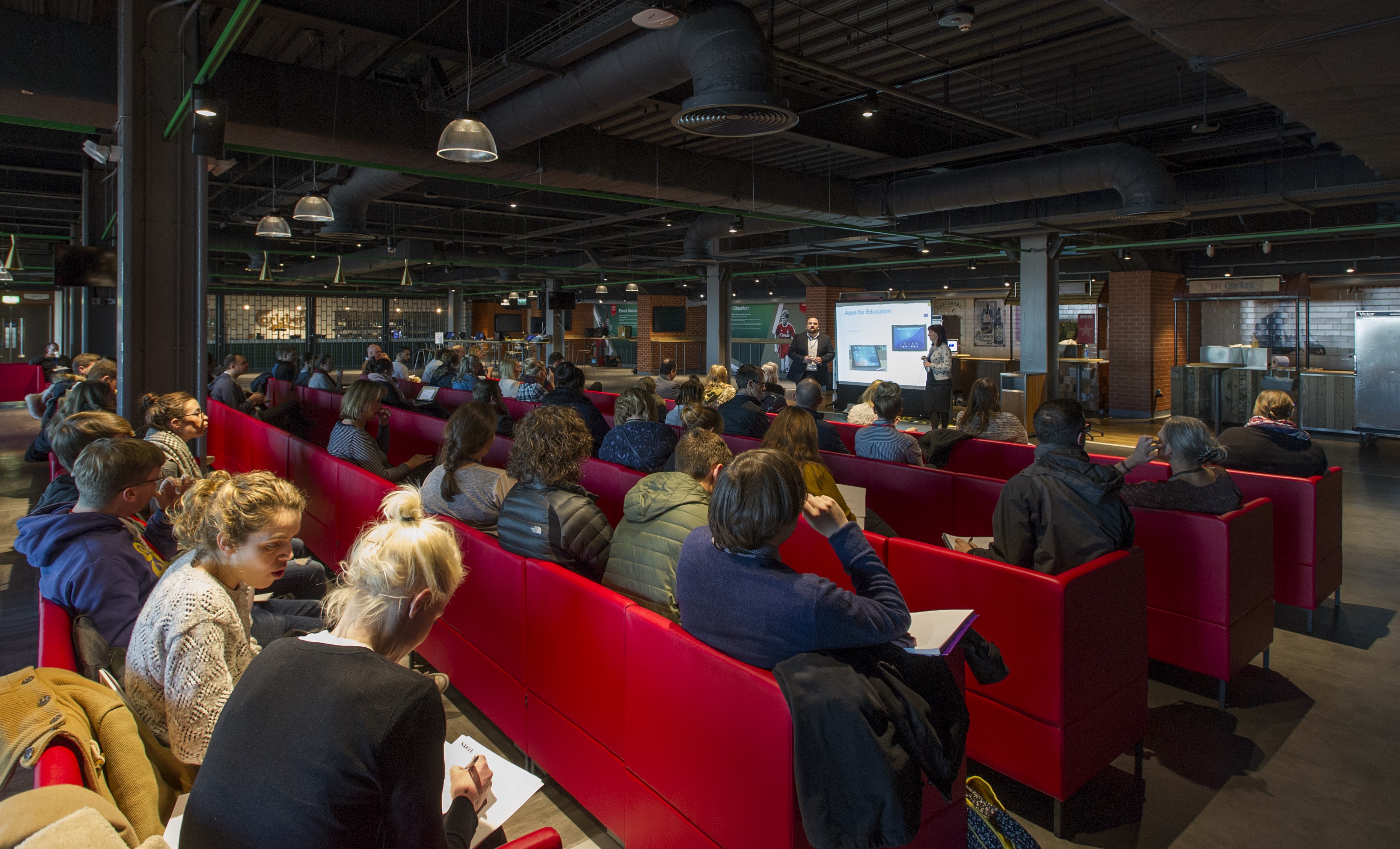 Carlsberg Dugout seminar with engaged audience in modern, comfortable seating.