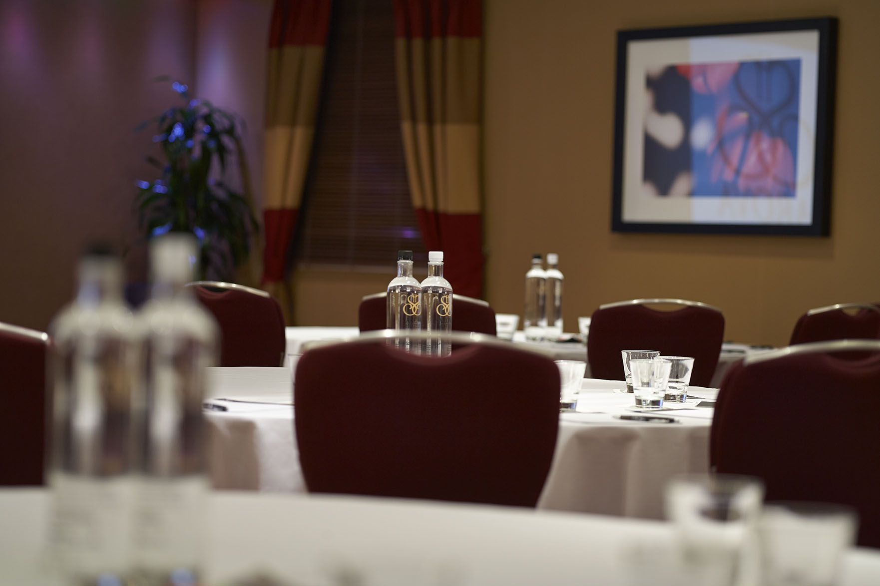 Chalfont Suite meeting room with round tables, perfect for conferences and events.