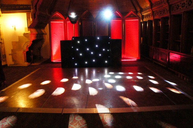 Long Gallery at Ettington Park Hotel with sleek black stage for events and celebrations.